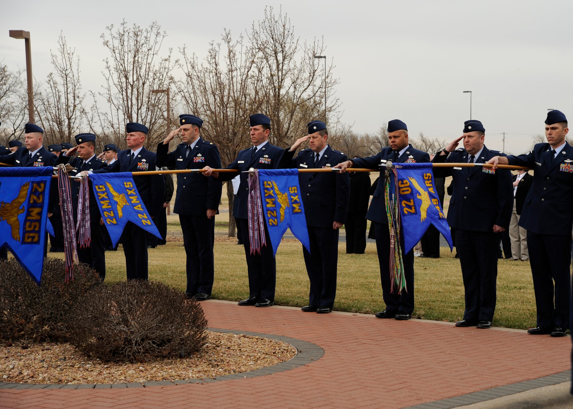 MCCONNELL AIR FORCE BASE, Kan. -- Airmen salute the American flag outside  building 1 during the flag folding ceremony held for Col. Michael V. Krueger, March 9. The flag was flown at half-staff for five days and then given to Colonel Krueger’s family. (Photo by Airman Justin Shelton) 