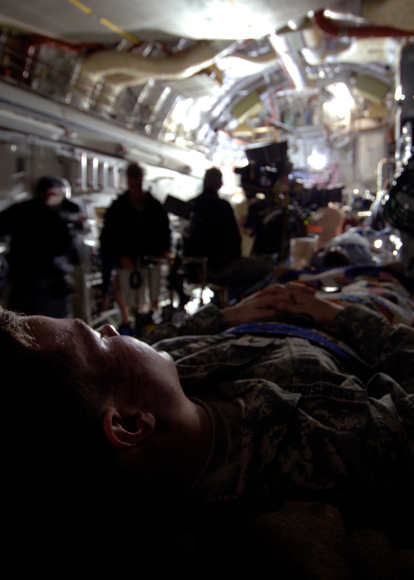 Staff. Sgt. Christopher Rhoton lies on a stretcher in the back of a C-17 while he waits for the Army Wives production crew to begin filming here March 10. Several Team Charleston Airmen were used as extras during the filming. Sergeant Rhoton is with the 373rd Training Squadron Detachment 5. (U.S. Air Force photo/Senior Airman Timothy Taylor)