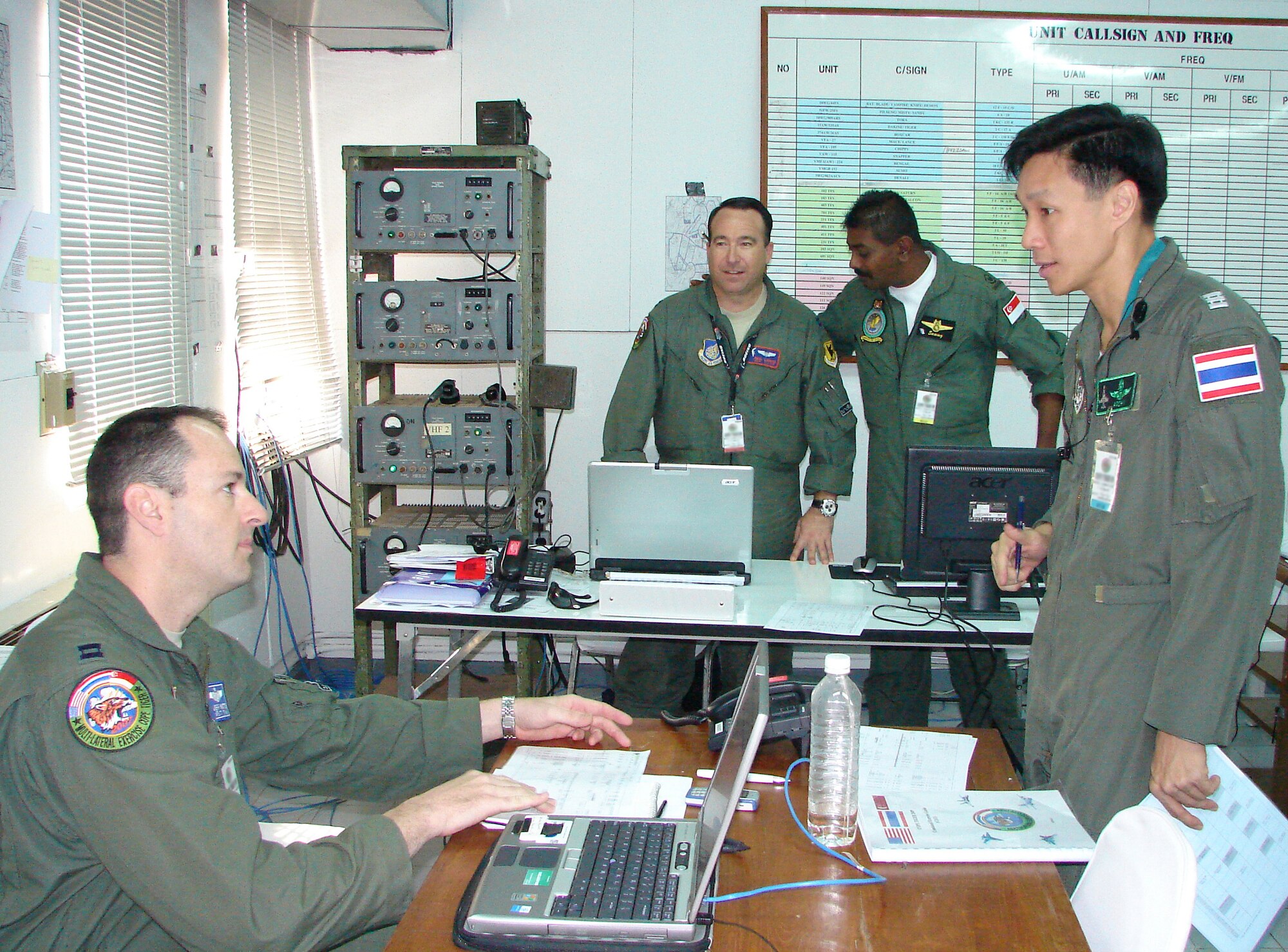 (Left to right) Capt. Jeff Watts, Capt. Paul Lankes, Republic of Singapore Warrant Officer Naranasamy Samyual and Royal Thai Air Force Wing Commander Arnon Charusombat discuss the Cope Tiger 2009 flying schedule in the live fly cell at Royal Thai Air Force Base, Thailand, March 11.  Cope Tiger is an annual, multilateral large force aerial exercise conducted in Thailand including U.S., Thai and Singaporean military forces.  The two-week exercise includes both aerial and humanitarian events.  (U.S. Air Force photo/Capt. Erika Yepsen)                              