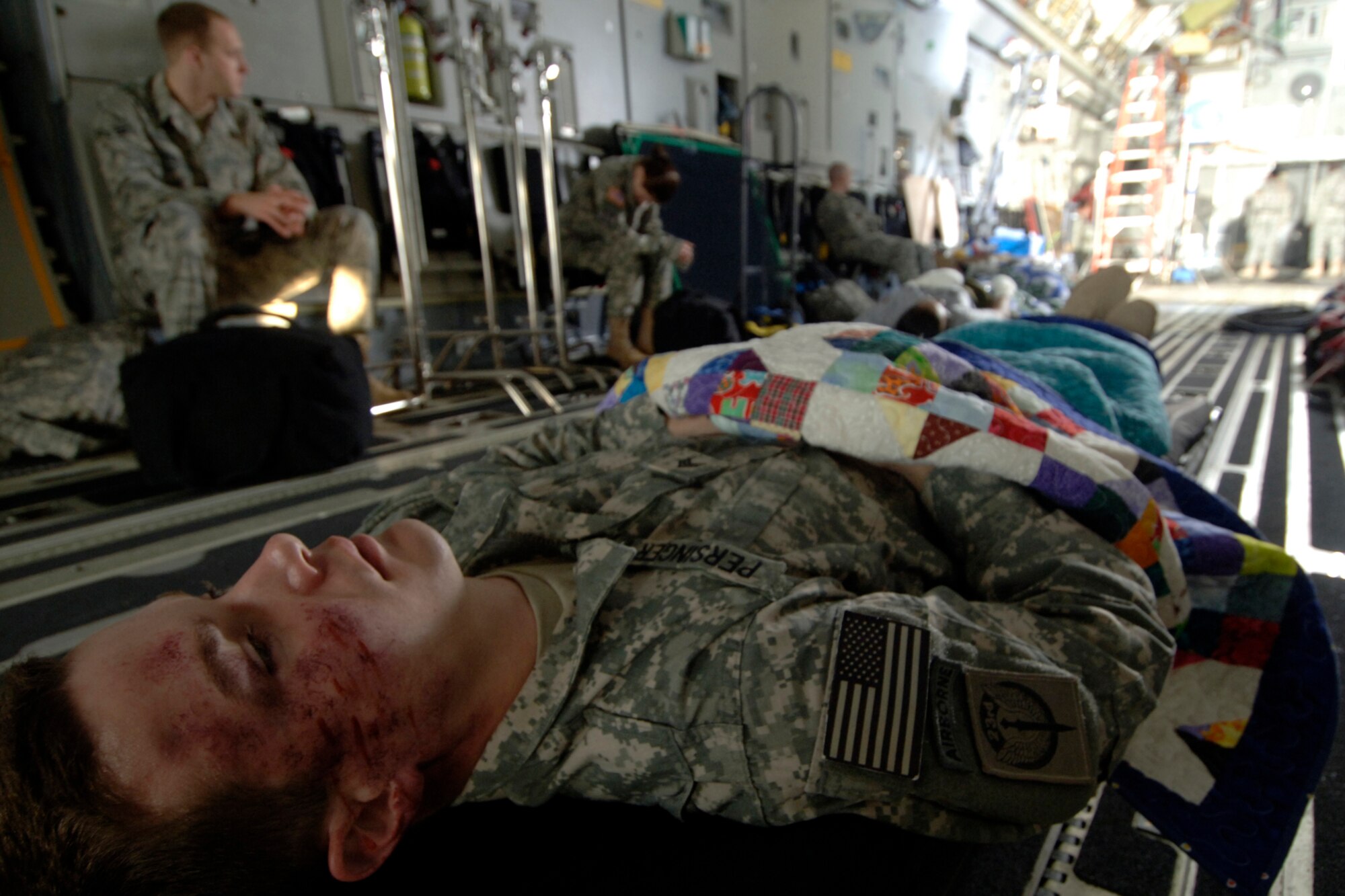 Staff Sgt. Christopher Rhoton lies on a stretcher in the back of a C-17 while he waits for Army Wives filming to begin. Sergeant Rhoton and several other Team Charleston Airmen were used as extras on the March 10 filming. He is assigned to the 373rd Training Squadron Detachment 5. (U.S. Air Force photo/Senior Airman Timothy Taylor)
