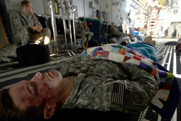 Staff Sgt. Christopher Rhoton lies on a stretcher in the back of a C-17 while he waits for Army Wives filming to begin. Sergeant Rhoton and several other Team Charleston Airmen were used as extras on the March 10 filming. He is assigned to the 373rd Training Squadron Detachment 5. (U.S. Air Force photo/Senior Airman Timothy Taylor)