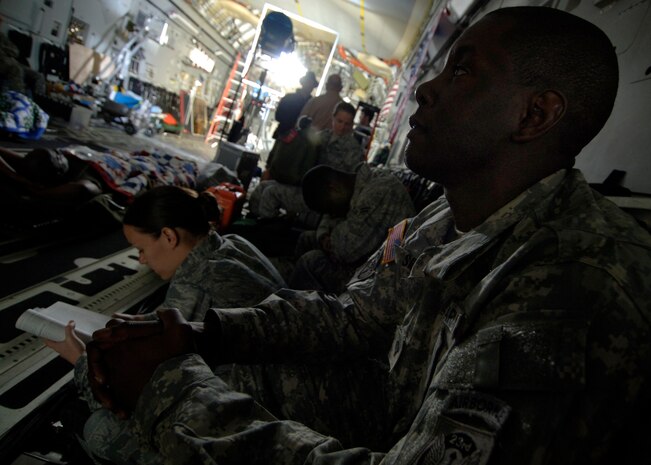 Tech. Sgt. Amos Seymore waits alongside other Charleston Airmen for the Army Wives production crew to begin filming inside a C-17 here March 10. In order to get a more authentic look, the Department of Defense and base leadership authorized filming at various locations around base. Sergeant Seymore is with the 437th Force Support Squadron. (U.S. Air Force photo/Senior Airman Timothy Taylor)