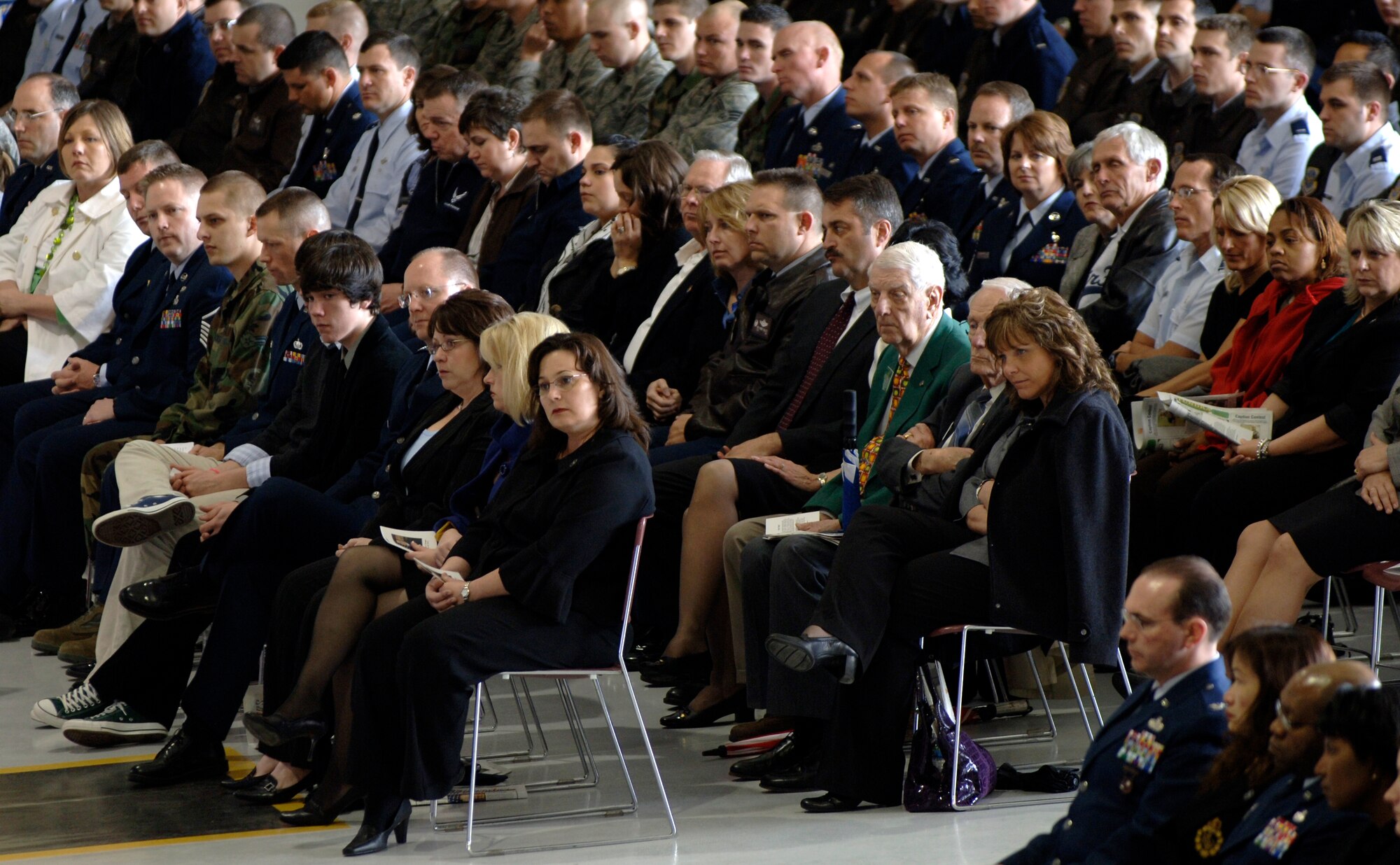 MCCONNELL AIR FORCE BASE, Kan. -- Team McConnell members and local Wichitans gather during Col. Michael V. Krueger’s memorial service in hangar 1176, March 9. The crowd of people listens as friends of Colonel Krueger spoke on his behalf and told stories in his remembrance. (Photo by Senior Airman Laura Suttles)