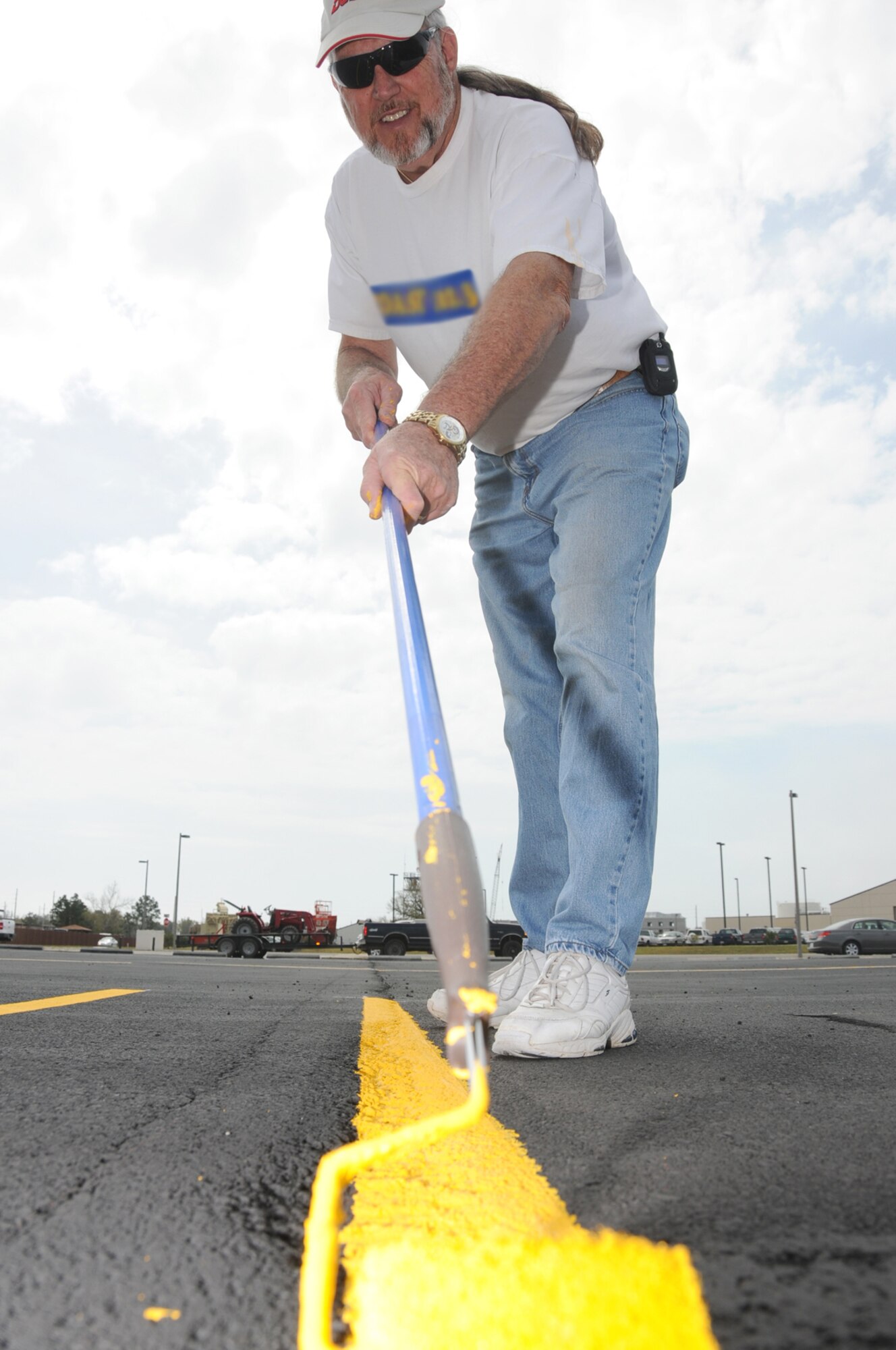 Jerry Gardner paints the motorcycle safety training area in the parking lot next to Dolan Hall Monday.  (U.S. Air Force photo by Kemberly Groue)