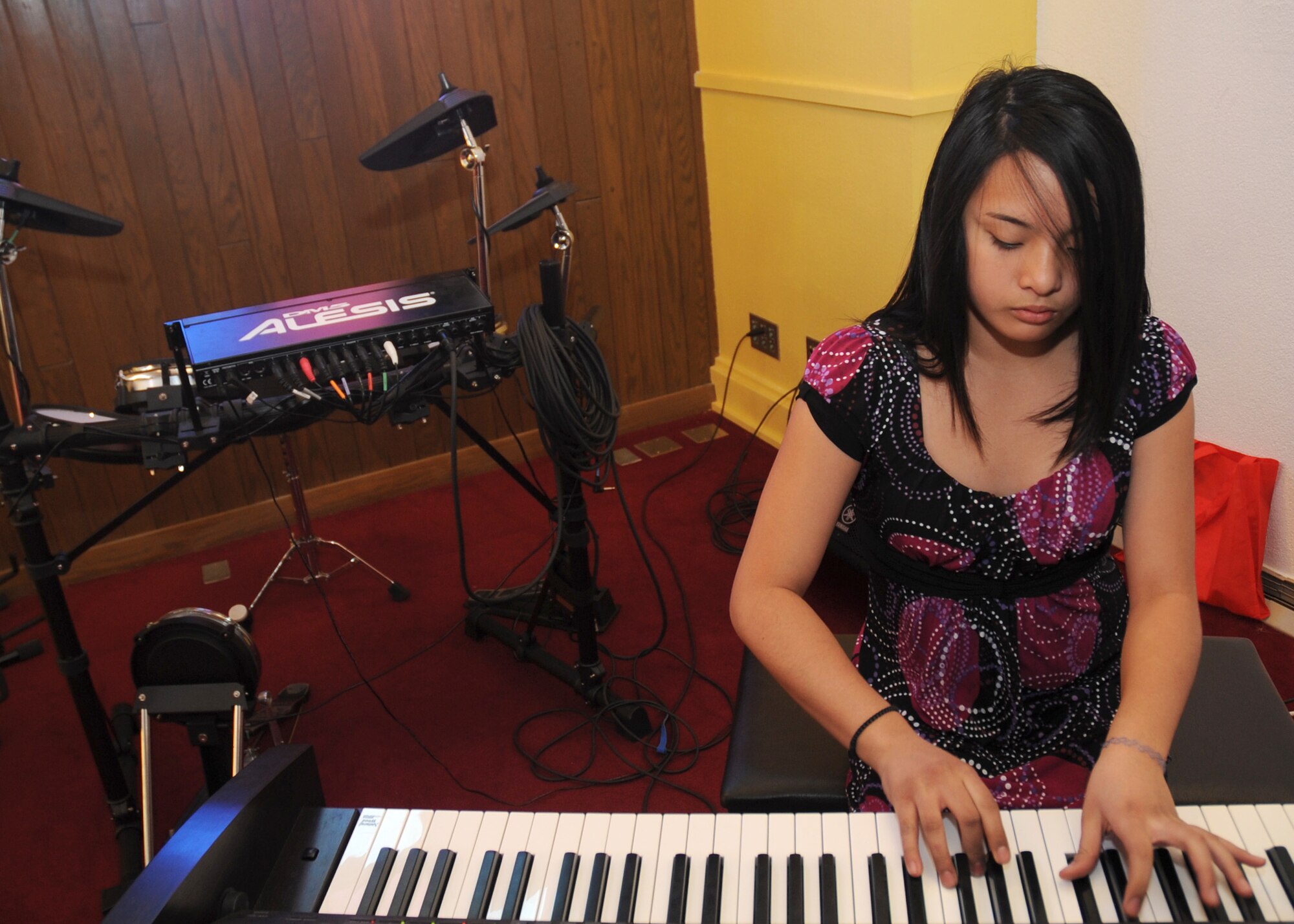 CANNON AIR FORCE BASE, N.M. -- Jennifer Suan, daughter of Master Sgt. Eric Suan, 27th Special Operations Support Squadron, plays the piano at the base chapel March 10.  Jennifer placed third in the preteen Solo Category of the 2008 Air Force Family & Teen Talent Contest. More than 160 participants were nominated by 37 installations for the AF-level competition. (U.S. Air Force photo/Senior Airman Liliana Moreno)