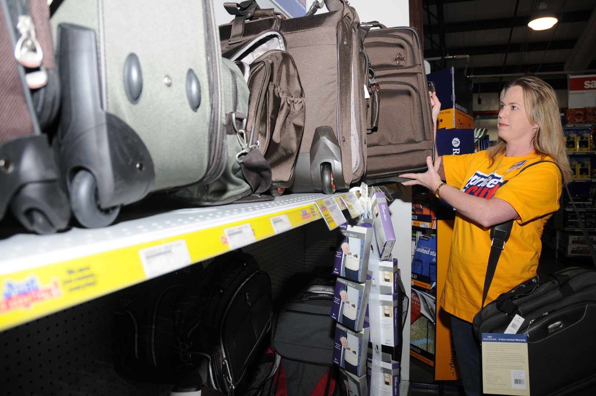 AAFES employee Wendy Cleland stocks luggage at the Keesler exchange.
(U.S. Air Force photo by Kemberly Groue)