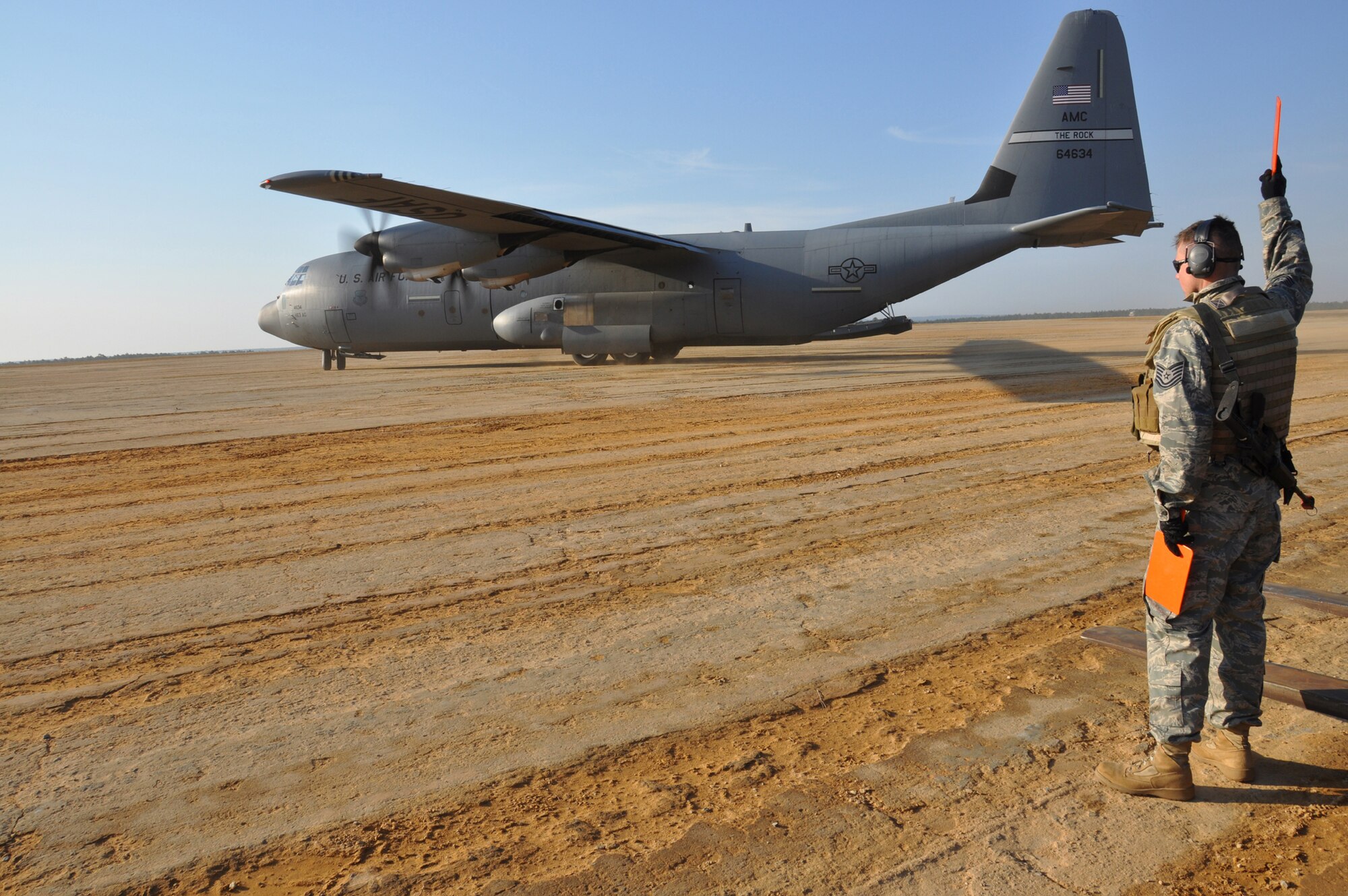 Staff Sgt. William Bullecks, a maintenance Airman with the 817th Contingency Response Group, marshalls in a C-130J during a Joint Forcible Entry Exercise at Fort Bragg, N.C., March 2-8. During the exercise, Airmen from the 621st Contingency Response Wing and Soldiers from the 689th Rapid Port Opening Element conducted an airfield assessment and exercised the Joint Task Force - Port Opening mission after an airfield seizure by the Army's 82nd Airborne Division. (U.S. Air Force photo/1st Lt. Dustin Doyle)