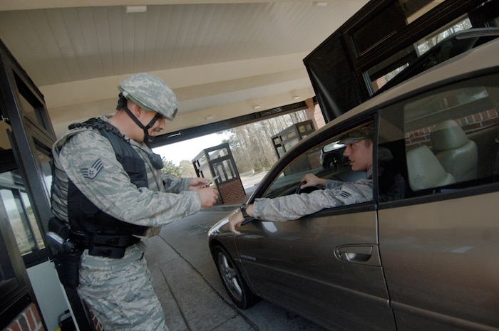 Staff Sgt. Mike Cote checks the military identification card of an Airman entering Charleston AFB, March 11. The base held an exercise to practice for possible real-world events and to also prepare for the upcoming emergency management inspection during the base’s unit compliance inspection in May.  Sergeant Cote is a patrolman with the 437th Security Forces Squadron. (U.S. Air Force photo/Senior Airman Timothy Taylor)