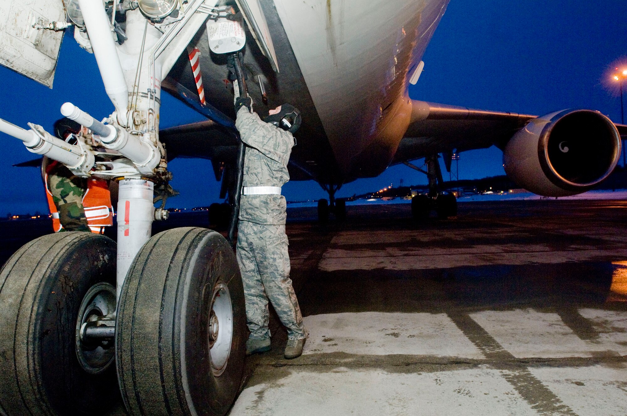 ELMENDORF AIR FORCE BASE, Alaska -- Staff Sgt. Shaun Archer, 732nd Air Mobility Squadron, hooks up power to a jet that will be used to transport 4th Brigade, 25th Infantry Division (Airborne) Soldiers to Afghanistan March 10, 2009. The 4th BDE 25th ID is deploying 3,500 Soldiers to perform counter-terrorism operations, aid with reconstruction, and educate and equip the Afghan national security forces. (U.S. Air Force photo/Senior Airman Jonathan Steffen)