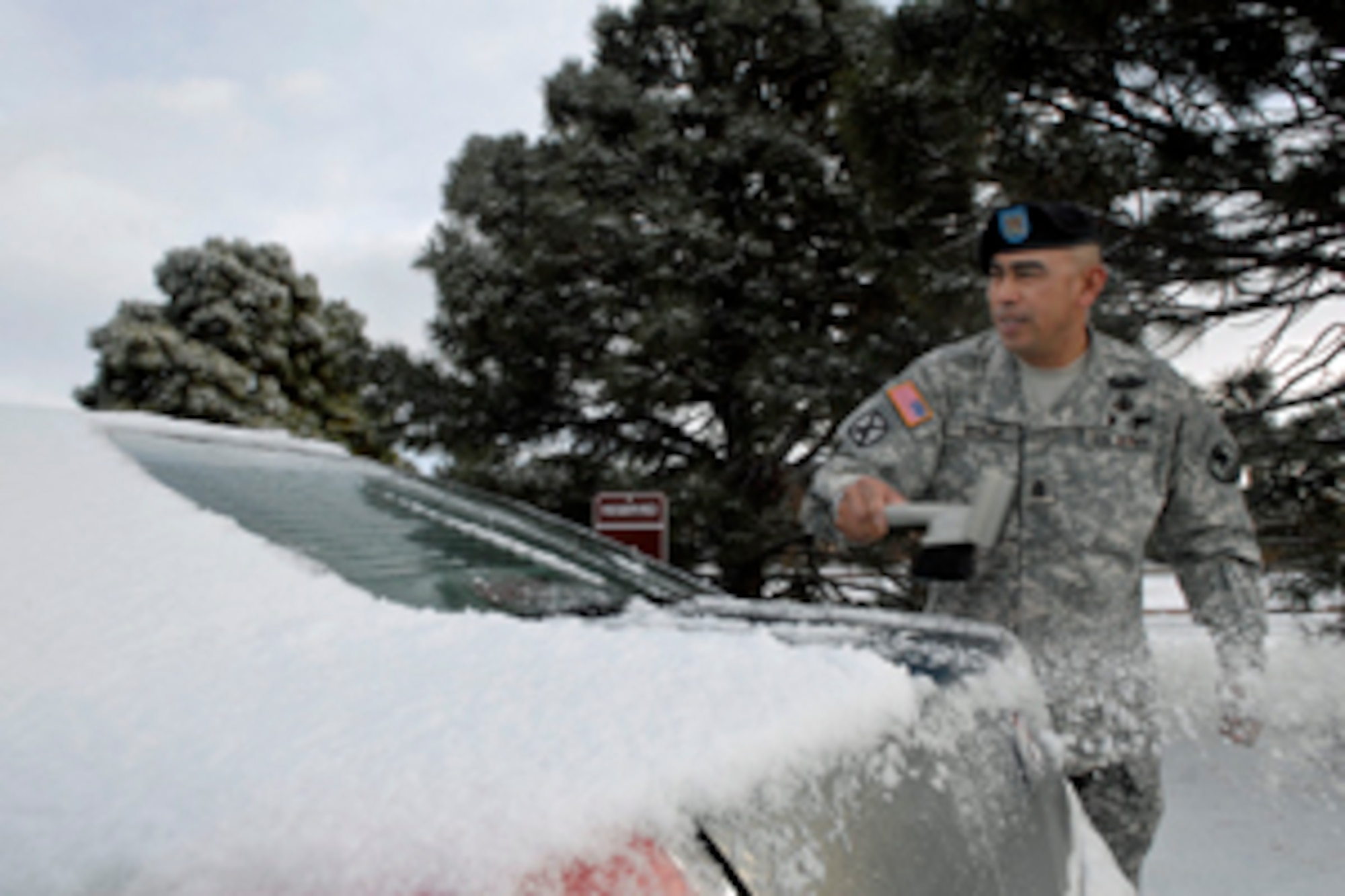 CSM Ralph C. Borja, Command Sgt. Maj. for SMDC/ARSTRAT, takes the time to clean off his rental car prior to travel during March 10's surprise snow flurries. 
Clearing accumulated snow off your vehicle is one of the first things that should be done before hitting the road. “Safety is a priority anywhere for any vehicle during adverse conditions”  stated CSM Borja as he was sweeping away the snow. “It’s best to be prepared”.  Followed by April, March is the heaviest snowfall month due to the unique Colorado Divide weather. It’s in your, and your family’s, best interests to continue to plan for cold weather until early summer.  Plan to be safe now; not sorry later. Stay vigilant and alive.
