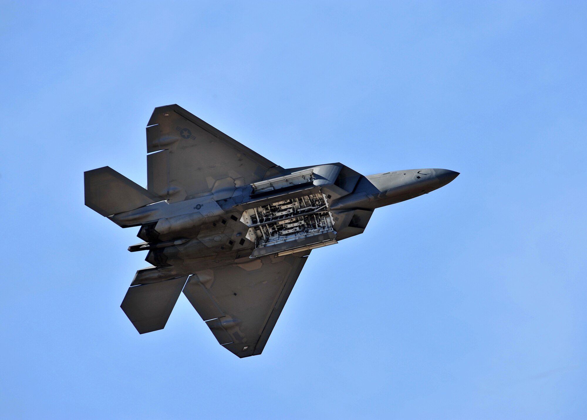 An F-22 Raptor opens its munitions bay during a practice demonstration flight at the Heritage Flight Conference here March 7. (U.S. Air Force photo/Senior Airman Noah R. Johnson)