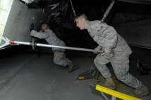 MINOT AIR FORCE BASE, N.D. -- Staff Sgt Deonta Griffin (left) and Airman 1st Class Ethan Payne, both 5th Aircraft Maintenance Squadron weapons load crew members, begin the task of loading weapons onto a B-52H Stratofortress during an Eighth Air Force inspected load crew competition, here Feb. 3. The Warbirds found out March 4 they took second place for non-conventional weapons loading. (U.S. Air Force photo by Senior Airman Kelly Timney)