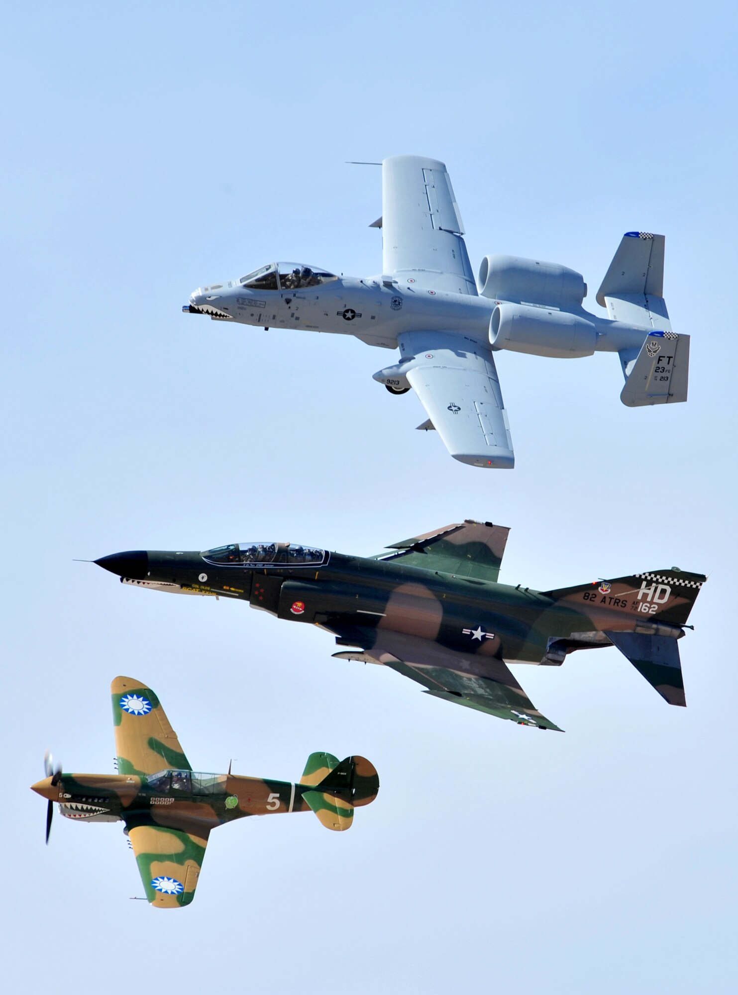 An A-10 Thunderbolt II (top), F-4 Phantom (middle), and P-40 Warhawk fly in formation during the Heritage Flight Conference here March 7. Pilots of old and new aircraft come to the HFC every year to practice demonstration flights together before the air show season. (U.S. Air Force photo/Senior Airman Noah R. Johnson)