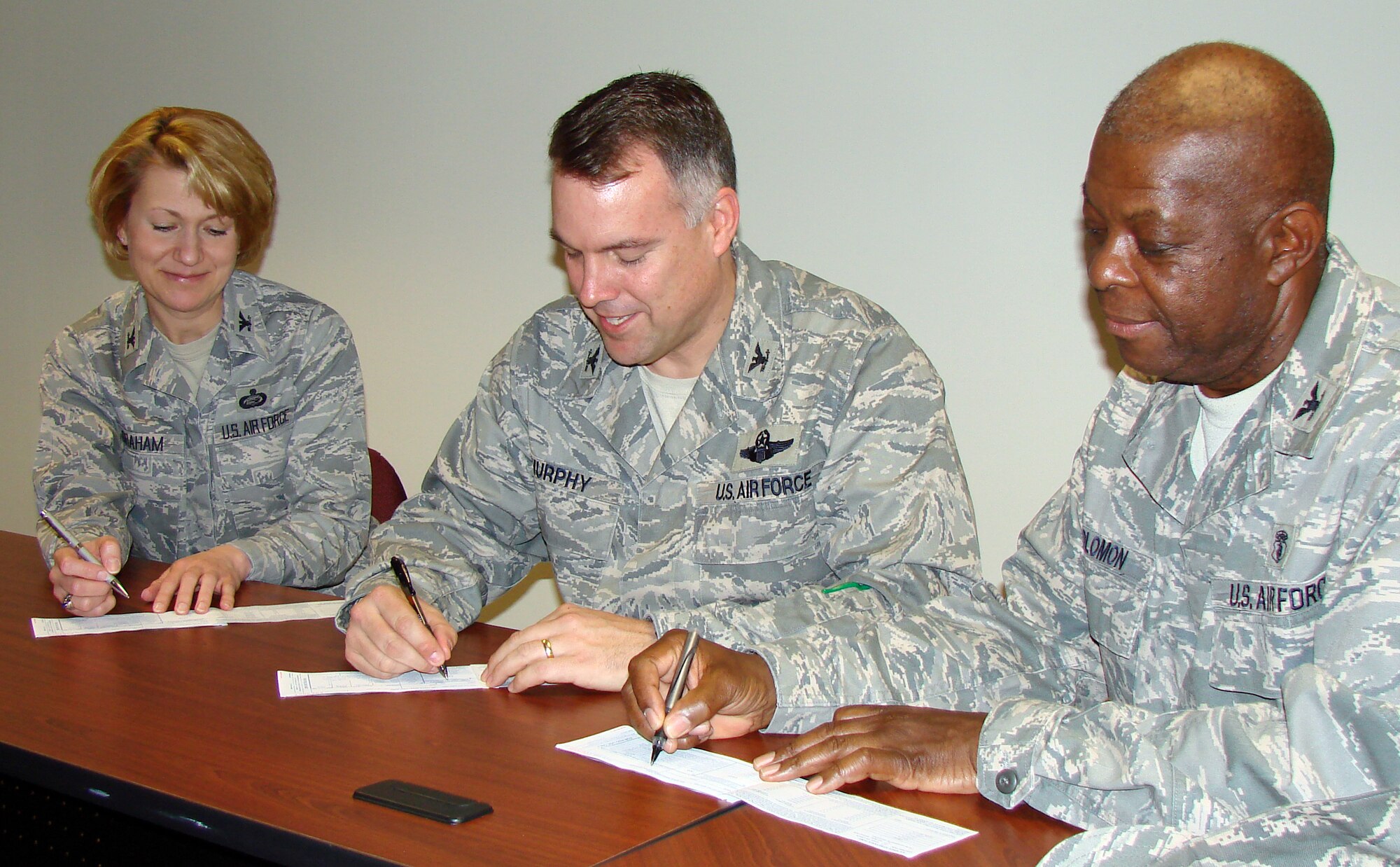 From left, Col. Jennifer Graham, 71st Mission Support Group commander; Col. Richard Murphy, 71st Flying Training Wing commander; and Col. Otha Solomon, 71st Medical Group commander, fill out their 2009 Air Force Assistance Fund donation forms during the Vance campaign luncheon, March 5, at the Airman & Family Readiness Center. (U.S. Air Force photo by Joe B. Wiles)