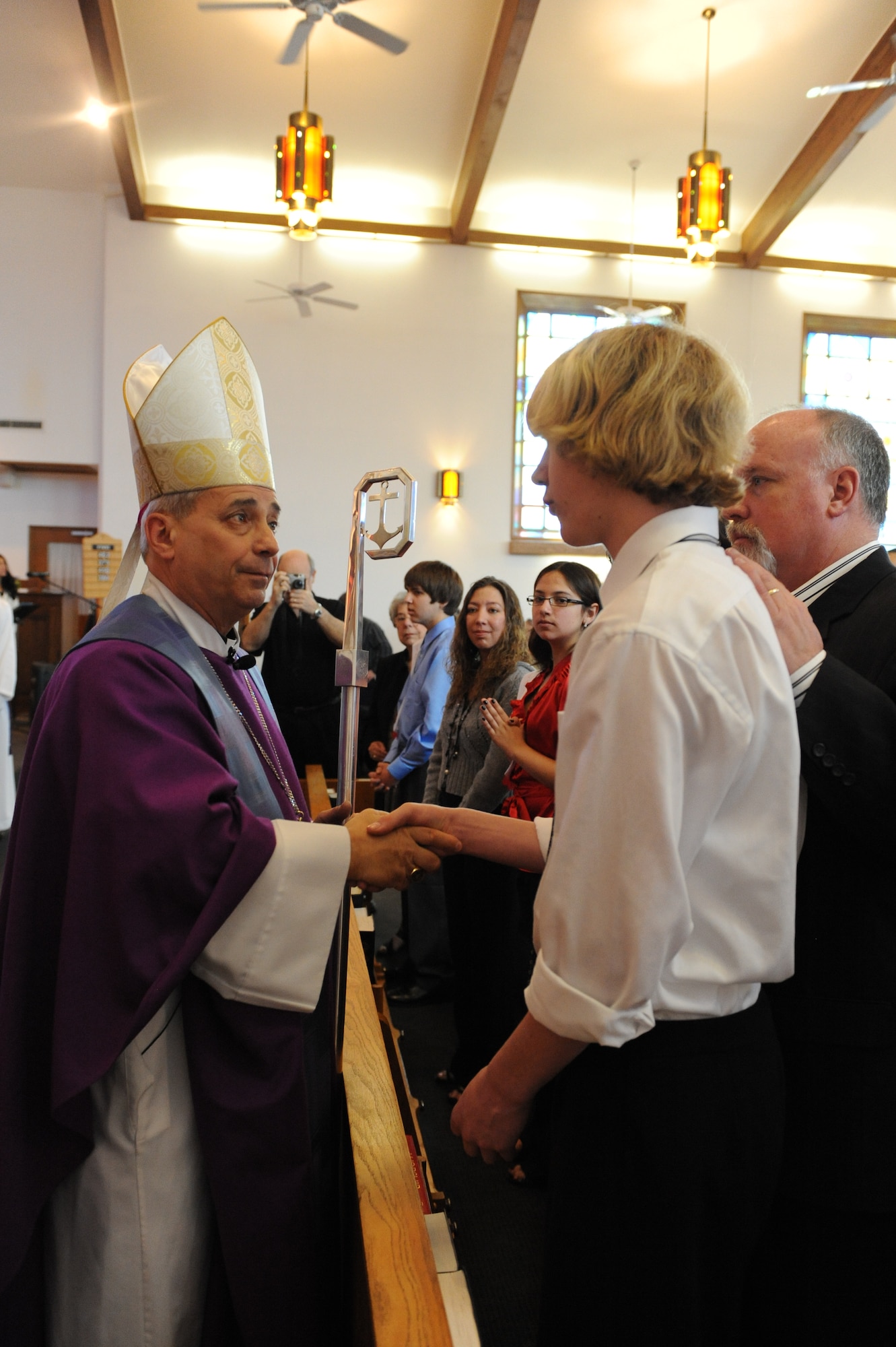 Auxiliary Bishop Joseph W. Estabrook, Auxiliary Bishop of the Archdiocese for the Military Services, U. S. A., greets parishioners at a ceremony for the Confirmation of Catholic youth at the Whiteman chapel March 8.  Bishop Estabrook last visited Whiteman four years ago and is retired from the US Navy.  
(U.S. Air Force photo/Senior Airman Cory Todd)
