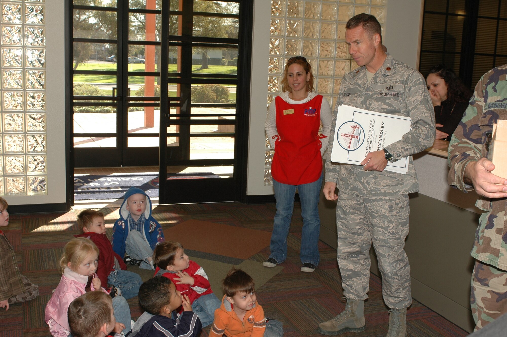 Maj. Keith Bland, USAF Band of the Golden West commander, speaks to children from Child Development Center 2 at the Bandhall March 10. During the trip, the children listened to two rehearsals and received band posters and CDs. (U.S. Air Force photo)


