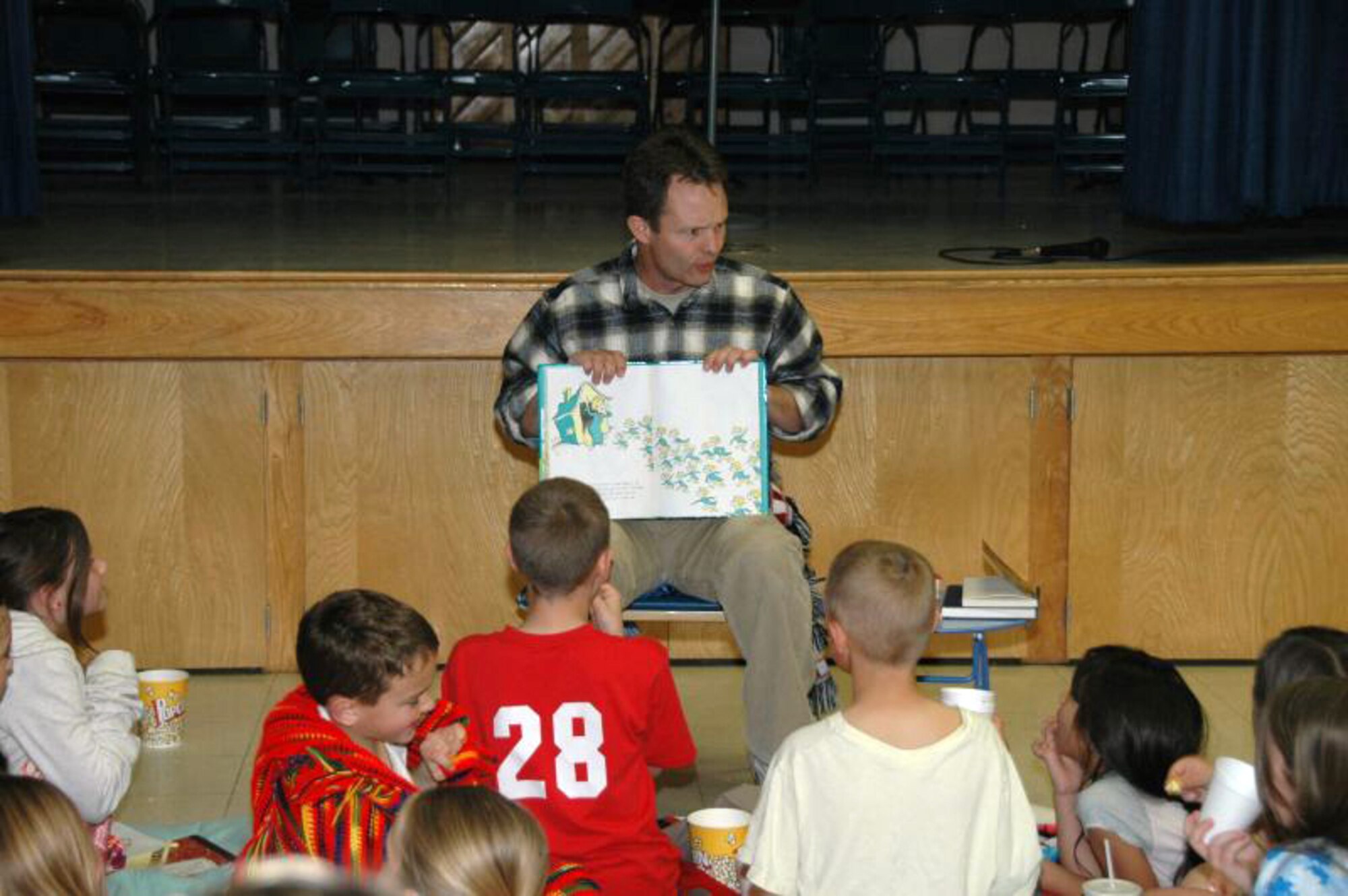 Col. Gale Skousen, 95th Medical Group chief of medical staff, reads to students during Branch Elementary School's story night  March 5. The theme of the event is "Get Wild About Reading." More than 270 students, parents and visitors participated in the event hosted by the Branch Parents and Teachers Organization. (Courtesy photo)