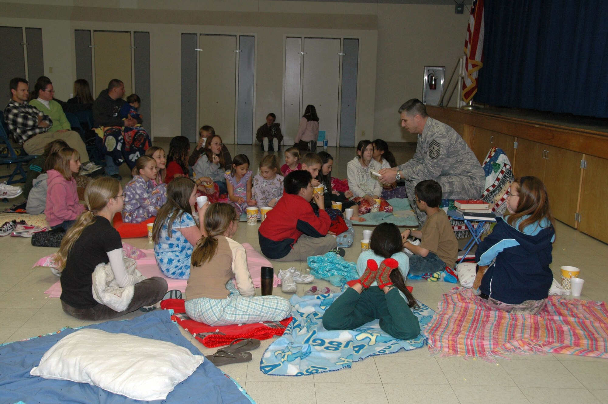 Chief Master Sgt. Eric Jaren, 95th Air Base Wing command chief, reads to students during Branch Elementary School's story night March 5. The theme of the event was "Get Wild About Reading." More than 270 students, parents and visitors participated in the event hosted by the Branch Parents and Teachers Organization. (Courtesy photo)