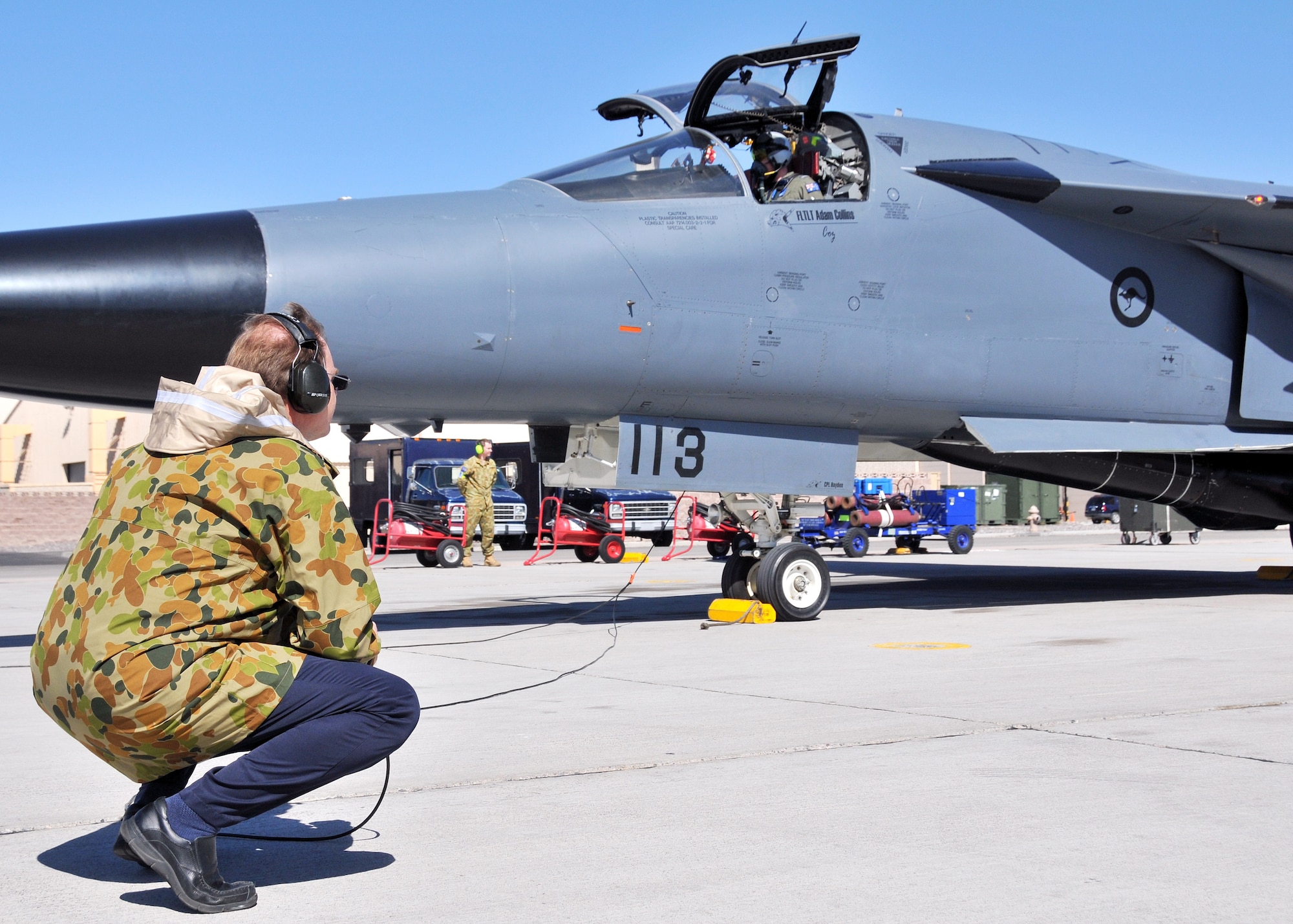 Mr. Fred Whitehead, a contractor at the 414th Combat Training Squadron (Red Flag), prepares to launch a Royal Australian Air Force F-111C during a  Red Flag exercise at Nellis Air Force Base, Nev., on Mar 11.  Mr. Whitehead was invited by the RAAF Red Flag team to launch this F-111, tail number 113, which he worked on as a crew chief in 1978.  This F-111 also flew the last official combat mission of the war in Southeast Asia in 1973.  (U.S. Air force photo by Gary Emery.)