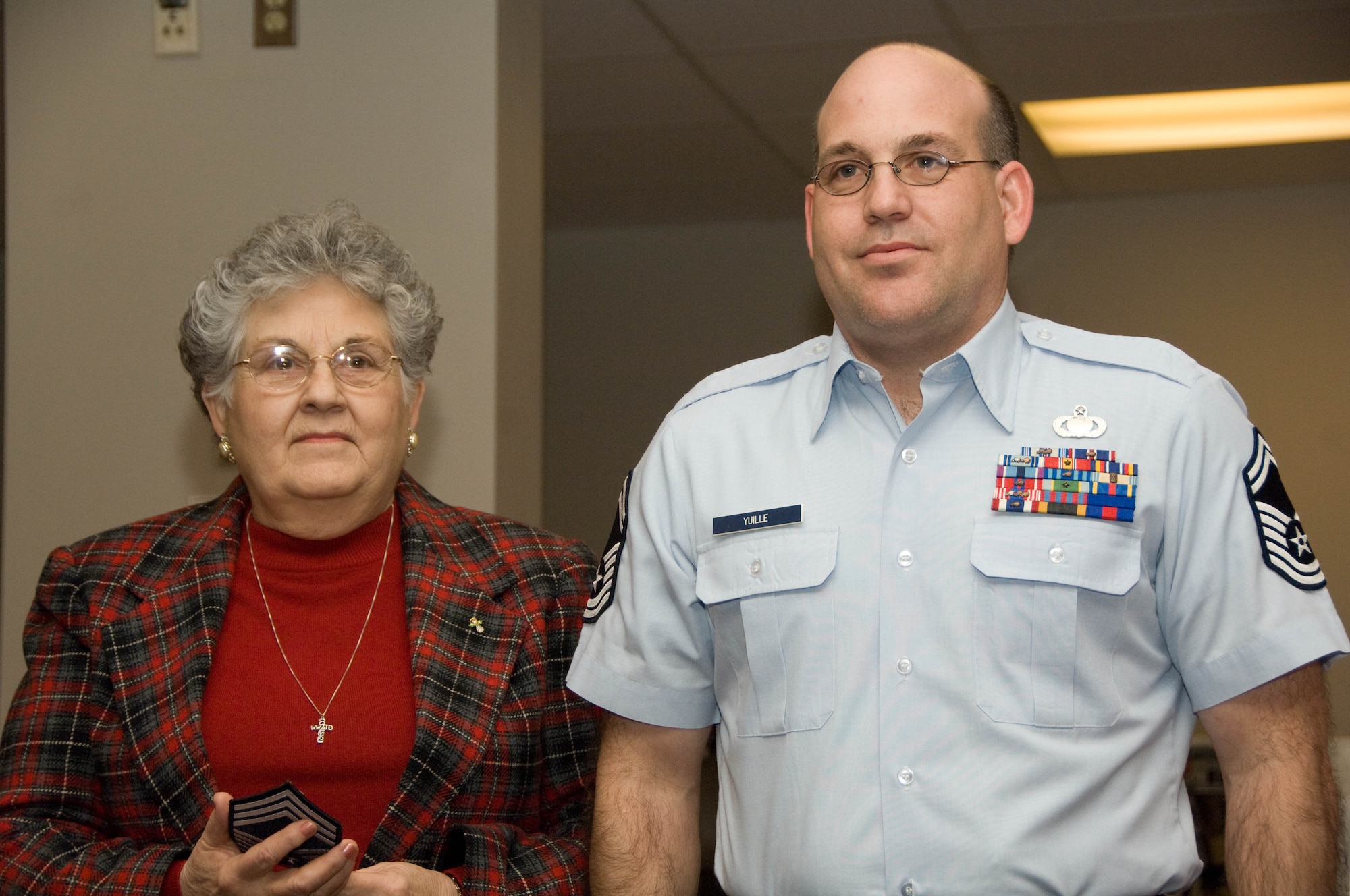 Senior Master Sgt. Mike Yuille, 139th Airlift Wing, stands at attention as he waits for his mother to put on his new Chief Master Sgt. stripes. Yuille was promoted to Chief Master Sgt. on March 8th, 2009. (U.S. Air Force photo by Tech. Sgt. Shannon Bond)