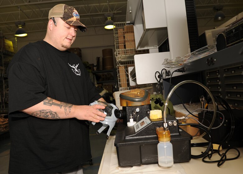 SCOTT AIR FORCE BASE, Ill. --Jim Ross, WRE material coordinator, inspects a gas mask using the newly acquired Joint Service Mask Leakage Test equipment. The JSMLT does a full system check of the mask to make sure it is ready upon issuance. 
U.S. Air Force photo/Staff Sgt. Paul Villanueva)