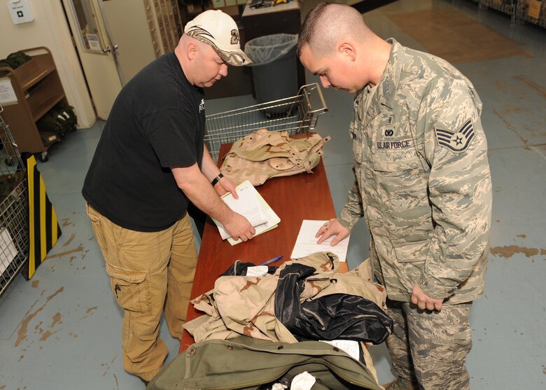 SCOTT AIR FORCE BASE, Ill. --John Divine, WRE material coordinator, issues a hand receipt to Staff Sgt. David Cook, 375th Aerospace Medicine Squadron, for chemical warfare gear that will be used in the upcoming exercise.(U.S. Air Force photo/Staff Sgt. Paul Villanueva)