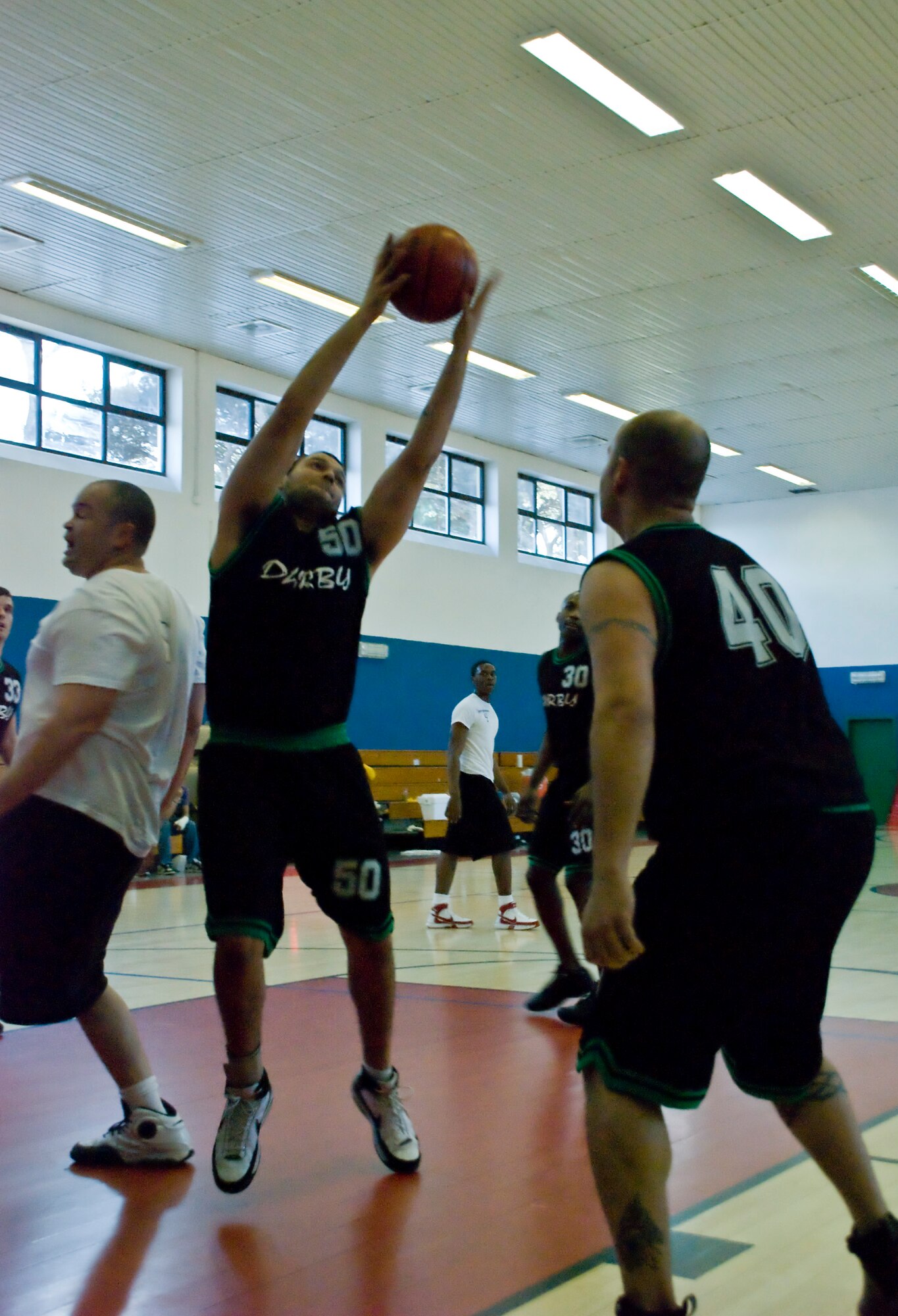 LIVORNO, Italy -- Camp Darby’s Joshua Aguire, 50, gets the rebound against Spangdahlem during the 2009 U.S. Air Force Europe Central Region Basketball Champions finals March 7, 2009. (U.S. Air Force photo by Joyce Costello)