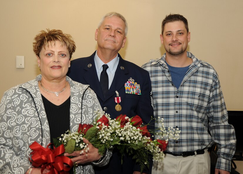 Senior Master Sgt. Jeffrey Capwell (center) poses with his wife Linda and son Jeffrey after Sgt. Capwell's offical retirement ceremony at Pope Air Force Base. Sgt. Capwell retired from the 440th Airlift Wing with 25 years of service in the Air Force Reserve and an additional four years on active duty. (U.S. Air Force photo by Master Sgt. Kevin Brody)