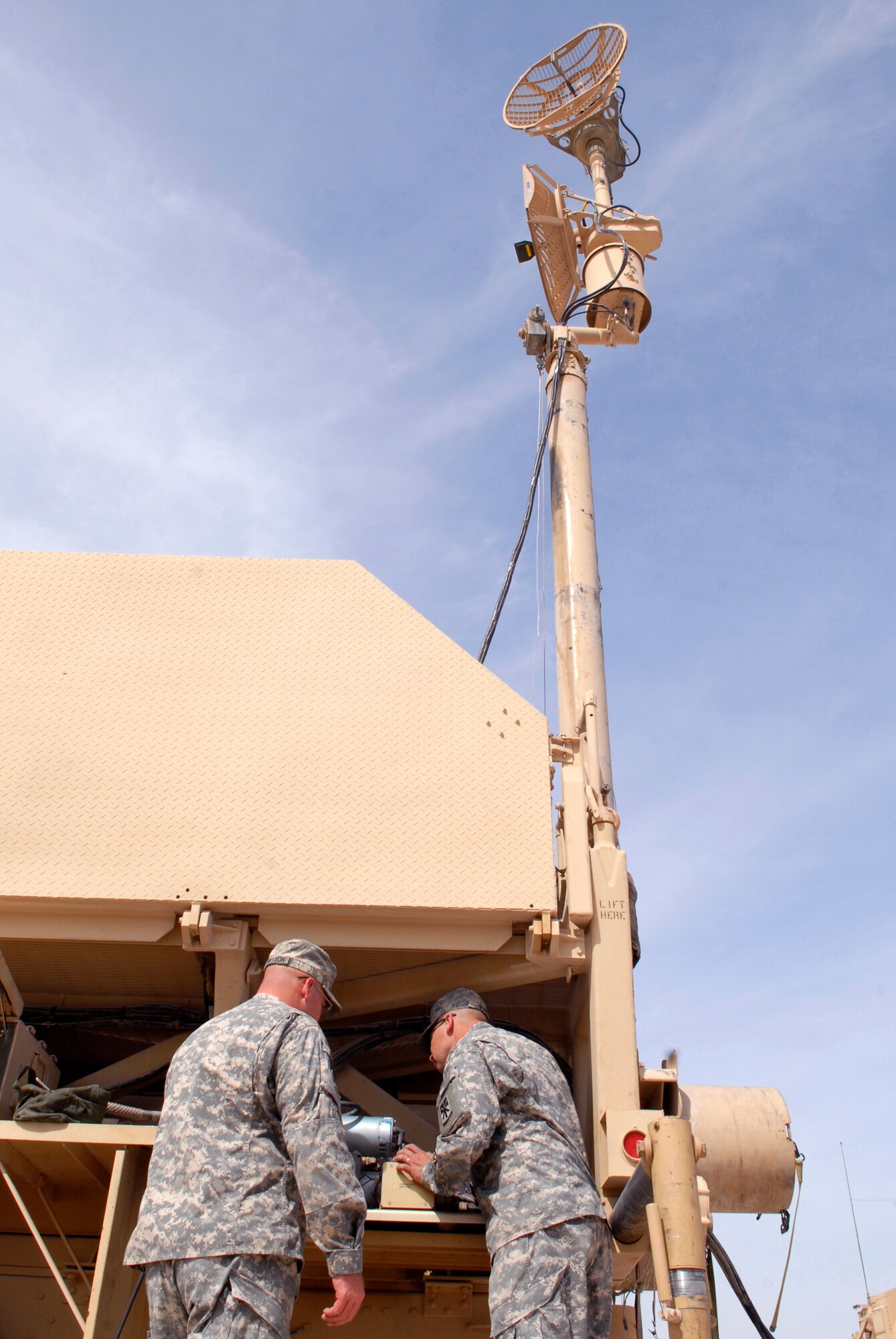 U.S. Army Spc. Toby Tennyson and Sgt. Henry Tye, 2-43 Air Defense Artillery Battalion technicians, check the air compressor motor which allows a radar antenna to rise, supporting constant communication capability for the patriot missiles, Mar. 10, 2009, at an undisclosed location in Southwest Asia.  Specialist Tennyson hails from Kaysville, Utah and Sergeant Tye hails from Tahlaquah, Okla.  Both are deployed from Fort Bliss, Texas in support of Operations Iraqi and Enduring Freedom and Combined Joint Task Force - Horn of Africa.  (U.S. Air Force Photo by Senior Airman Andrew Satran/Released)
