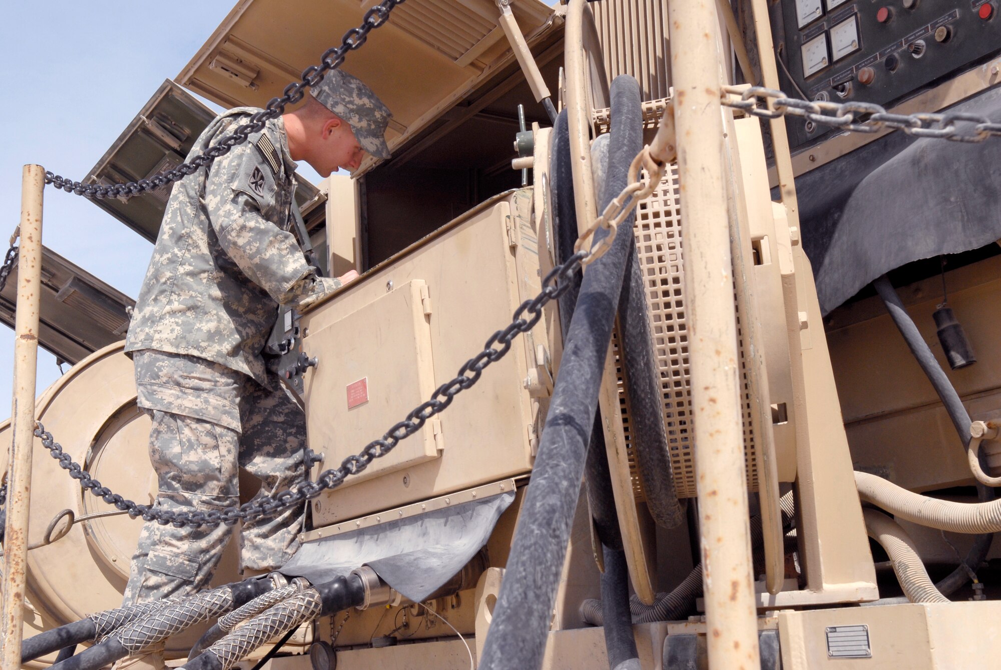 U.S. Army Spc. Justin Bayliss, Alpha 2-43 Air Defense Artillery Battalion Technician, changes an oil filter for an electrical power plant vehicle during routine maintenance, Mar. 10, 2009, at an undisclosed location in Southwest Asia.  Specialist Bayliss hails from Cleveland, Okla. and is deployed from Fort Bliss, Texas in support of Operations Iraqi and Enduring Freedom and Combined Joint Task Force - Horn of Africa.  (U.S. Air Force Photo by Senior Airman Andrew Satran/Released)