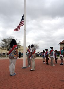 Randolph Girl Scout troops raise the flag during a ceremony outside Gaylor Airman Leadership School March 10. (U.S. Air Force photo by Steve White)