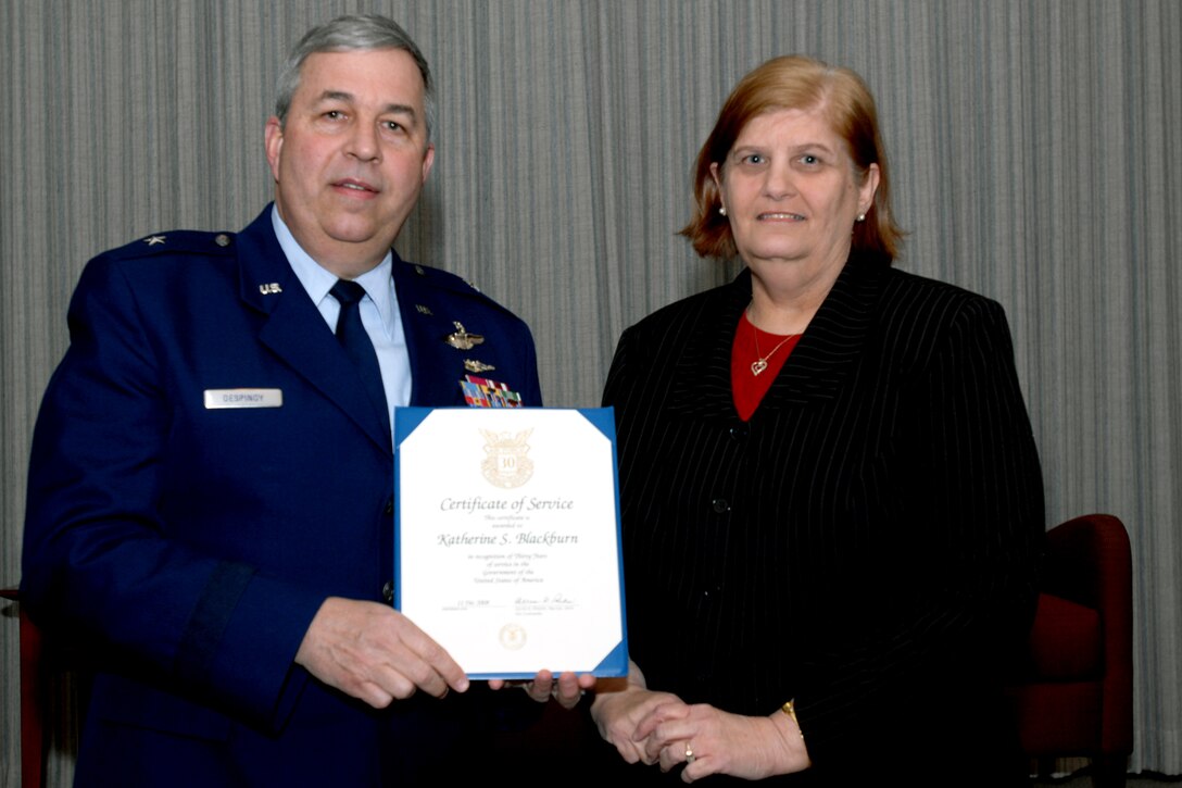 GRISSOM AIR RESERVE BASE, Ind., -- Brig. Gen. Dean Despinoy, 434th Air Refueling Wing commander, presents a 30-year pin and certificate to Kathy Blackburn, 434th Security Forces Squadron, marking her 30 years of federal service.  (U.S. Air Force photo/Tech. Sgt. Doug Hays)