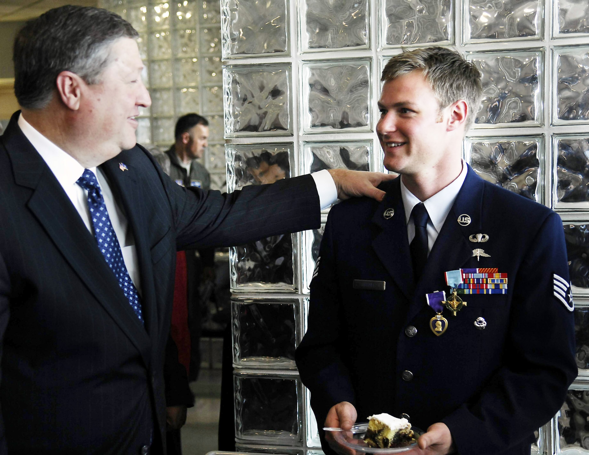 Secretary of the Air Force Michael B. Donley talks to Staff Sgt. Zachary Rhyner after a ceremony to present the NCO the Air Force Cross March 10 at Pope Air Force Base, N.C. Sergeant Rhyner of the 21st Special Tactics Squadron received the medal and a Purple Heart for uncommon valor during Operation Enduring Freedom for his actions during an intense 6.5-hour battle in Shok Valley, Afghanistan, April 6, 2008.  (U.S. Air Force photo)
