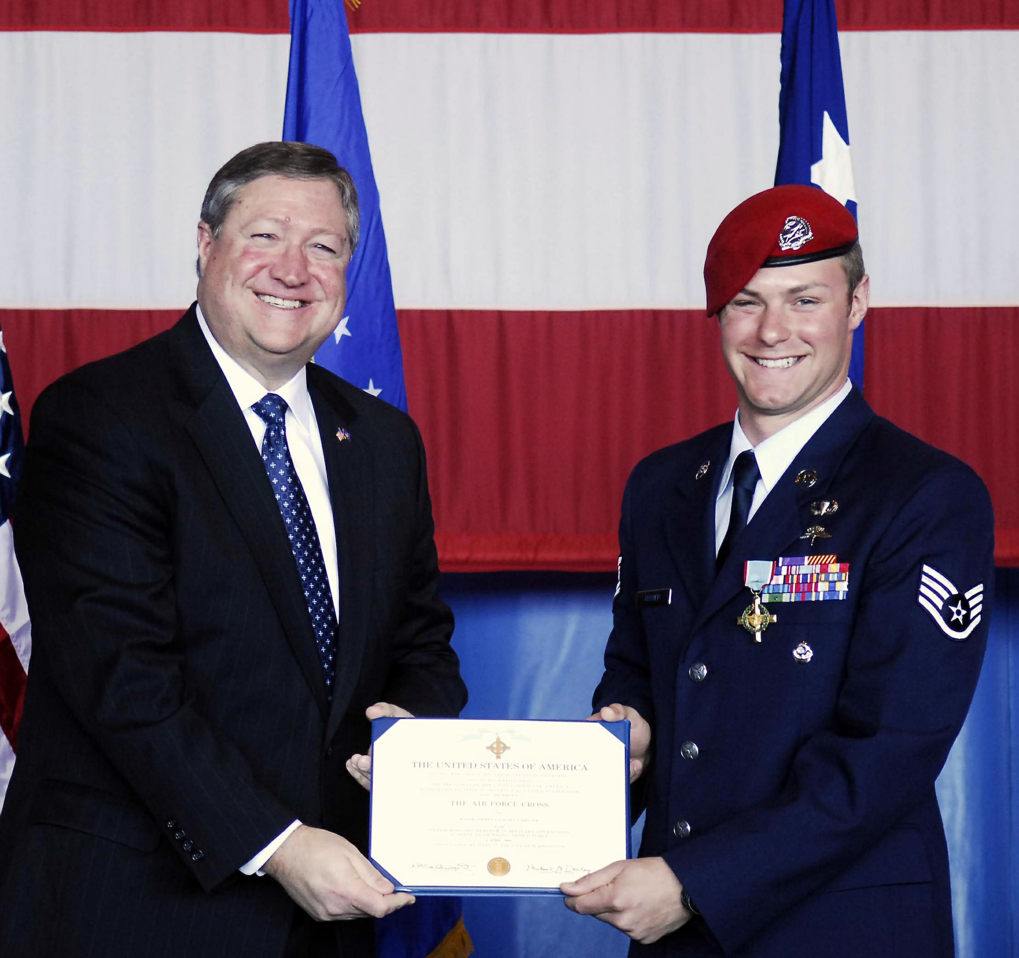 Secretary of the Air Force Michael B. Donley presents Staff Sgt. Zachary Rhyner the Air Force Cross March 10 at Pope Air Force Base, N.C. Sergeant Rhyner of the 21st Special Tactics Squadron received the medal for uncommon valor during Operation Enduring Freedom for his actions during an intense 6.5-hour battle in Shok Valley, Afghanistan, April 6, 2008.  (U.S. Air Force photo)
