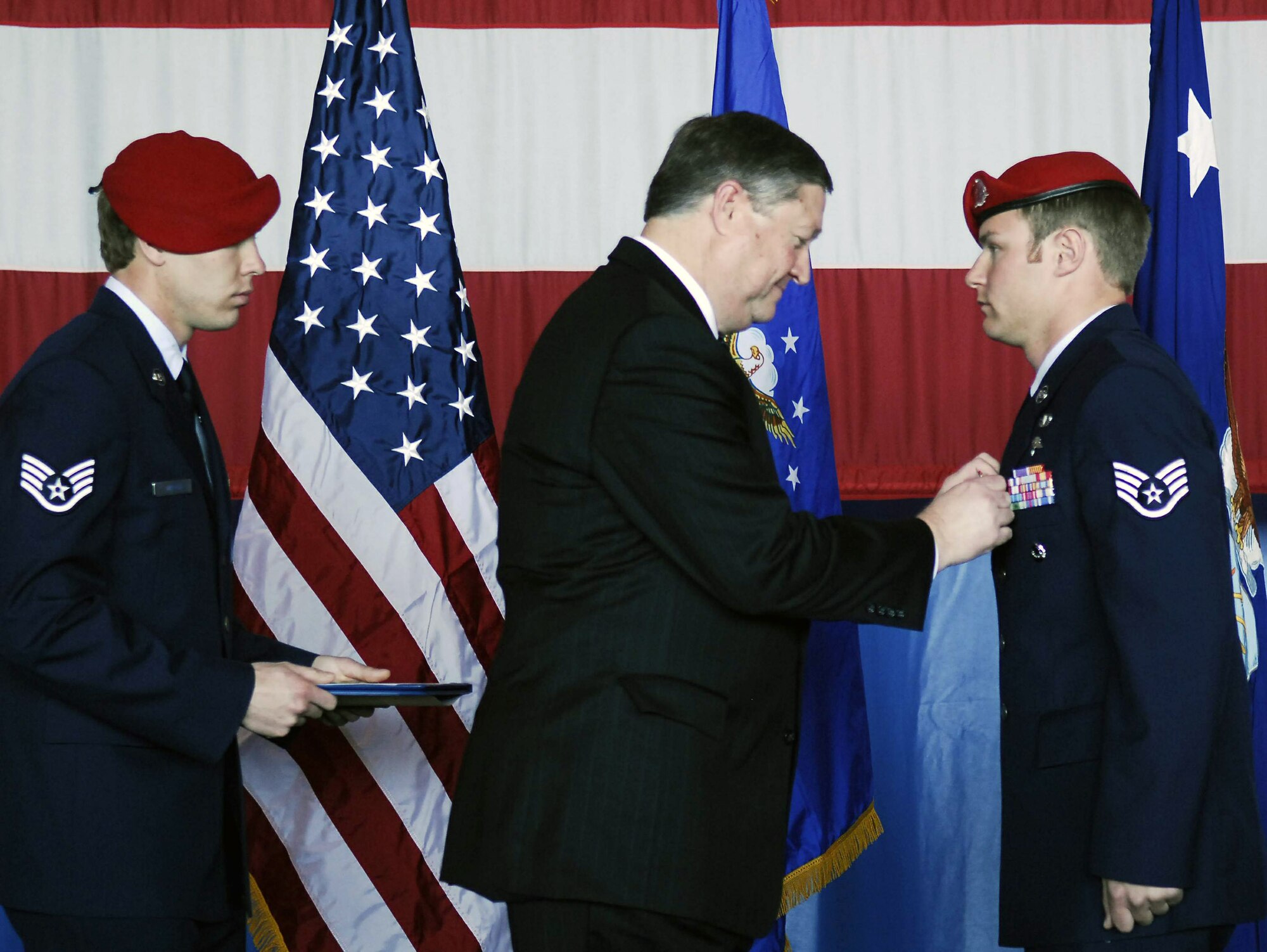 Secretary of the Air Force Michael B. Donley presents Staff Sgt. Zachary Rhyner the Air Force Cross March 10 at Pope Air Force Base, N.C. Sergeant Rhyner of the 21st Special Tactics Squadron received the medal for uncommon valor during Operation Enduring Freedom for his actions during an intense 6.5-hour battle in Shok Valley, Afghanistan, April 6, 2008.  (U.S. Air Force photo)
