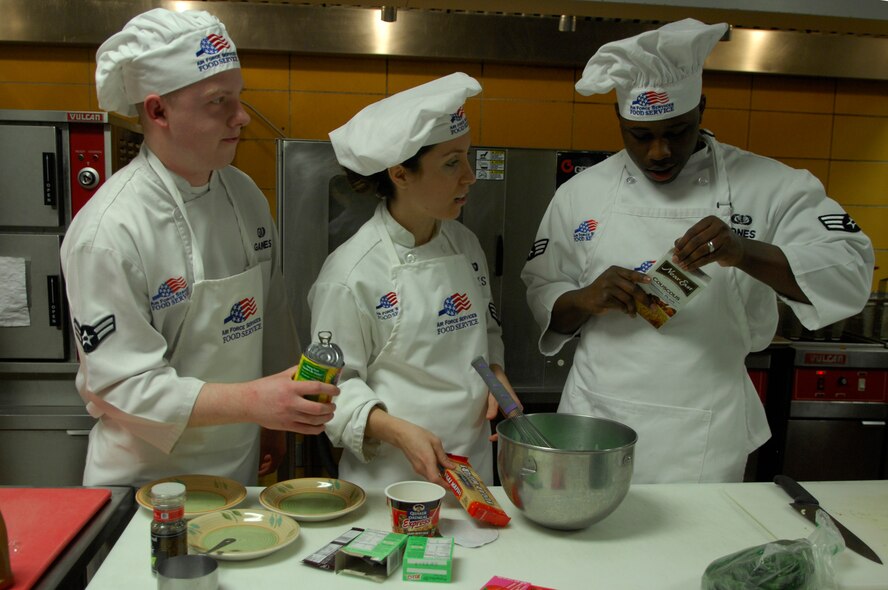 MINOT AIR FORCE BASE, N.D. --  Airman 1st Class Ernest Gaines, Senior Airman Andres Flores, and Senior Airman Courteney Jones, all chefs from the 91st Operations Group, prepare their pistachio and couscous desert during the 2009 Warrior Chef Challenge here, March 5. The Warrior Chef Challenge is a competition where two teams battle head-to-head and see who can prepare the best meal without knowing the actual ingredients. This has been the first year that the 5th Bomb Wing has participated in the challenge. (U.S. Air Force photo by Senior Airman Joe Rivera)