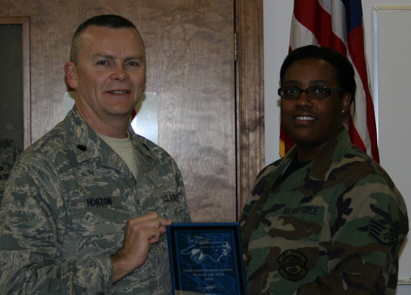 SEYMOUR JOHNSON AIR FORCE BASE, N.C. -- Lt. Col. James Horton (left), commander of the 916th Communication Squadron, presents the 916th Communication Squadron Non-commissioned Officer of the Year award to Staff Sgt. Veronica Jefferson during the March unit training assembly.