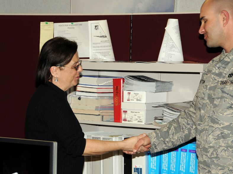 SEYMOUR JOHNSON AIR FORCE BASE, N.C. -- First Sergeant Justin Patton (right) gives a Raleigh Police Department coin to Ms. Donna Lea of the 916th Public Affairs Office in early March. Ms. Lea was instrumental in arranging a KC-135R air-to-air refueling flight for officers from the Raleigh PD. The 916th Air Refueling Wing educates nearly 300 business and community leaders each year on the mission of the Reserve wing through their public affairs flight programs.