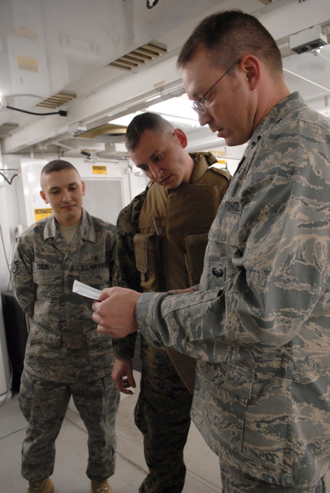 Staff Sgt. James Cook, 8th Medical Support Squadron; Hospital Corpsman 2nd Class Brian Melin, Marine Wing Support Squadron 171; and Capt. Matthew Glynn 8th MDSS, read directions while conducting joint training at Kunsan Air Base, Republic of Korea, March 11, 2009. HM2 Melin and Sergeant Cook are training on converting frozen blood to usuable blood for patient care. (US Air Force Photo By: Senior Airman Angela Ruiz)(Released by:8th Fighter Wing, Public Affairs Office,