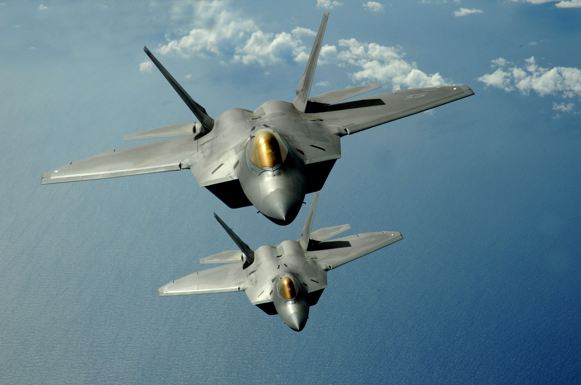 Two F-22 Raptors fly over the Pacific Ocean during a theater security mission March 9. The Raptors are deployed from Elmendorf Air Force Base, Alaska to the 90th Expeditionary Fighter Squadron Andersen Air Force Base, Guam. Fourteen of the $140 million dollar aircraft, and more than 250 Airmen have been here since January for a three month deployment as the Pacific's Theater Security Package. The stealth-fighters, along with associated maintenance and support personnel will participate in various exercises that provide routine training in an environment different from their home station. 

(U.S. Air Force photo/ Master Sgt. Kevin J. Gruenwald) released


















  












 











































  












 

























