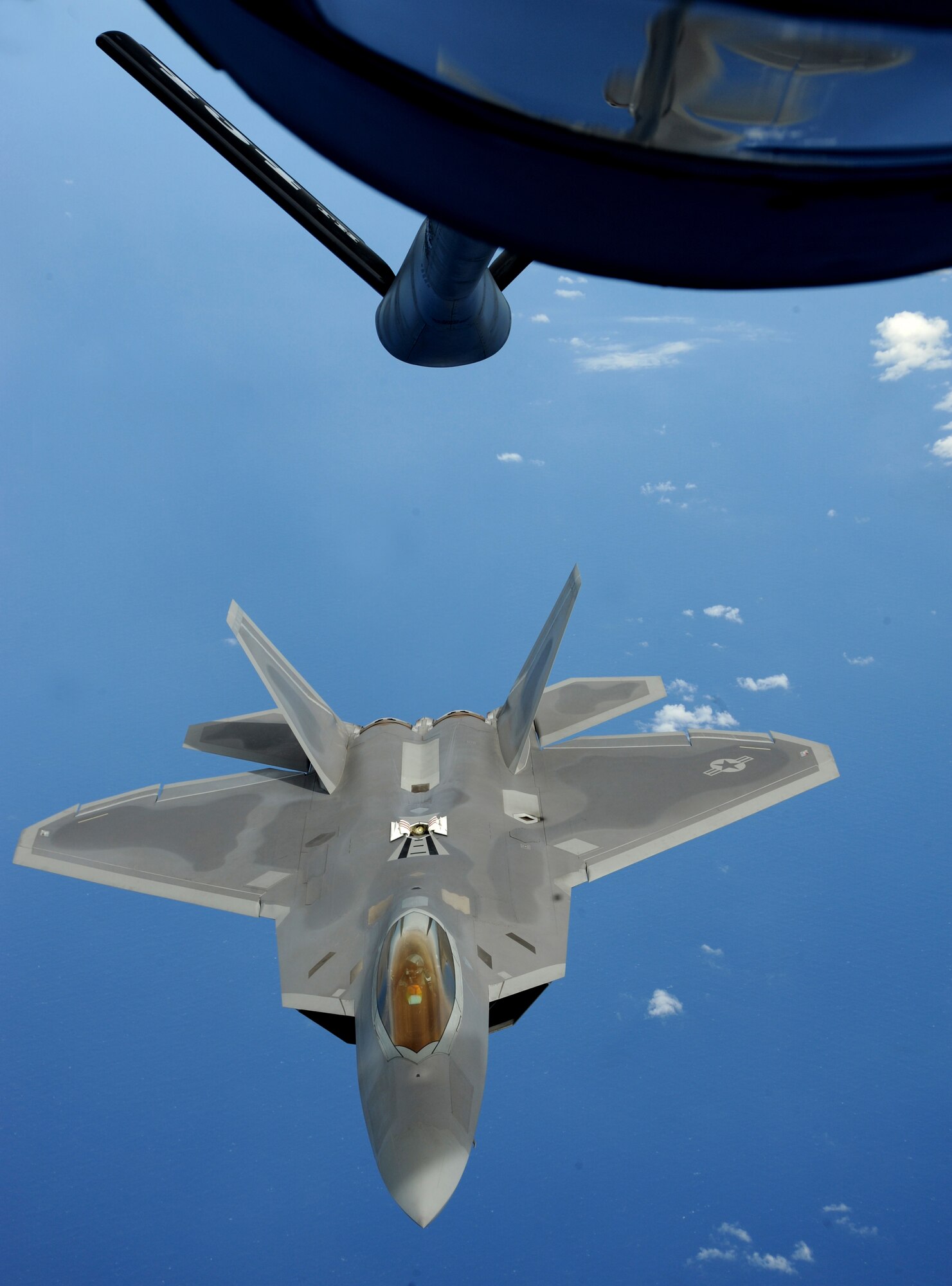 An F-22 Raptor moves into refueling position over the Pacific Ocean March 9. The Raptors are deployed from Elmendorf Air Force Base, Alaska to the 90th Expeditionary Fighter Squadron Andersen Air Force Base, Guam. The stealth-fighters, along with associated maintenance and support personnel will participate in various exercises that provide routine training in an environment different from their home station. The F-22 is a highly maneuverable  combat aircraft that can avoid enemy detection, cruise at supersonic speeds, and provide the joint force commander an unprecedented level of integrated situational awareness.

(U.S. Air Force photo/ Master Sgt. Kevin J. Gruenwald) released

















  












 











































  












 

























