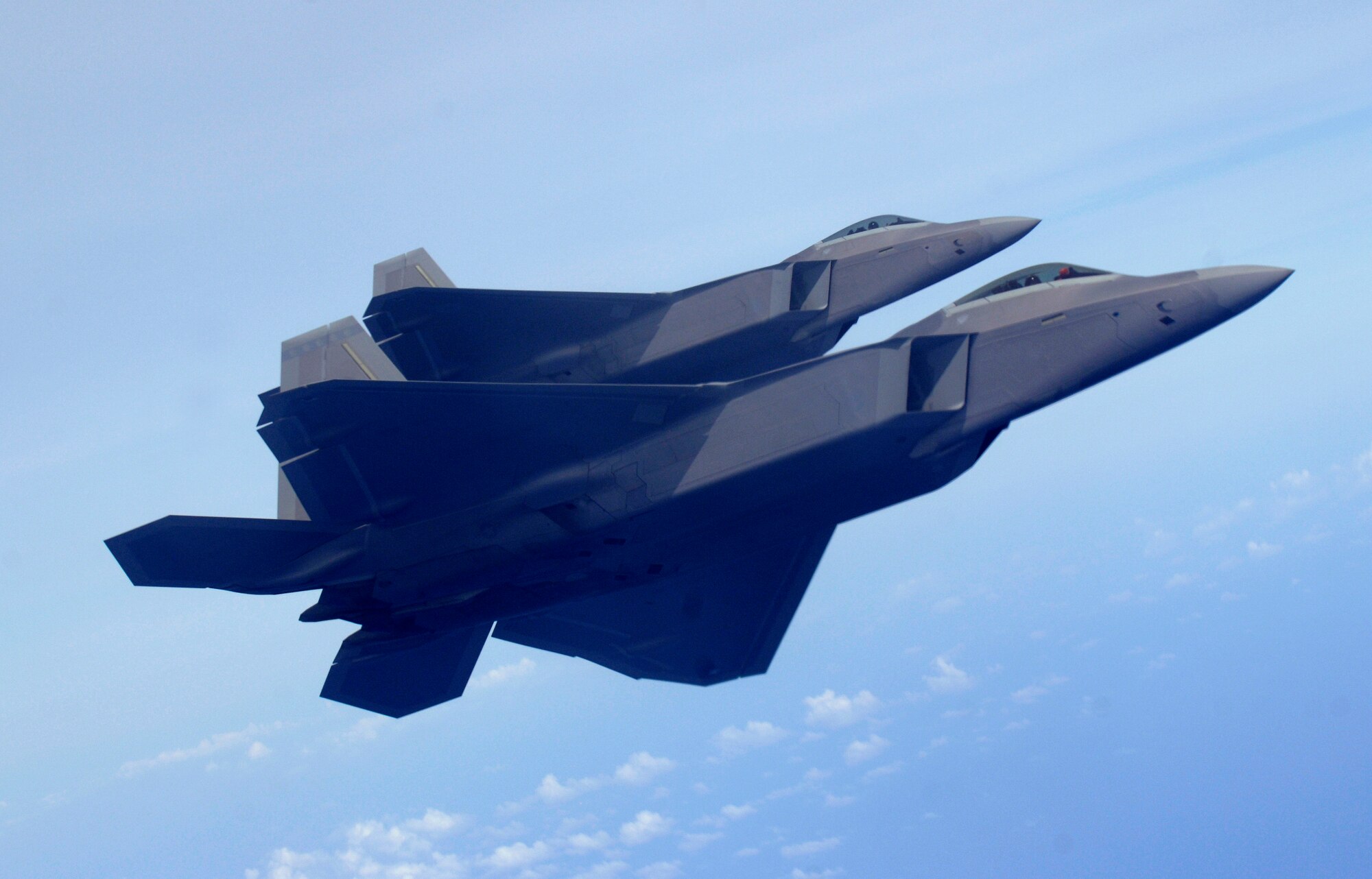 Two F-22 Raptors fly over the Pacific Ocean after a refueling mission March 9. The Raptors are deployed from Elmendorf Air Force Base, Alaska to the 90th Expeditionary Fighter Squadron Andersen Air Force Base, Guam. Fourteen of the $140 million dollar aircraft, and more than 250 Airmen have been here since January for a three month deployment as the Pacific's Theater Security Package. The stealth-fighters, along with associated maintenance and support personnel will participate in various exercises that provide routine training in an environment different from their home station. 

(U.S. Air Force photo/ Master Sgt. Kevin J. Gruenwald) released












  












 











































  












 

























