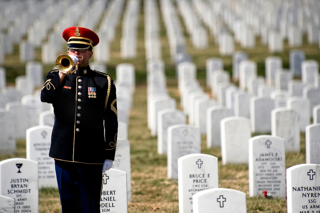 A lone U.S. Army bugler plays taps at the conclusion of the First Annual Remembrance Ceremony in Dedication to Fallen Military Medical Personnel at Arlington National Cemetery,  March 11, 2009.




