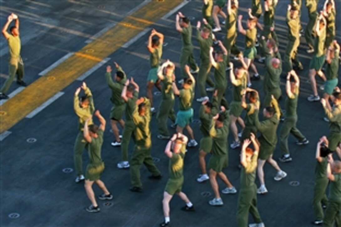 U.S. Marine Corps corporals perform side-straddle hops on the flight deck of USS Iwo Jima in the Suez Canal, March 1, 2009. The Marines are assigned to the 26th Marine Expeditionary Unit.