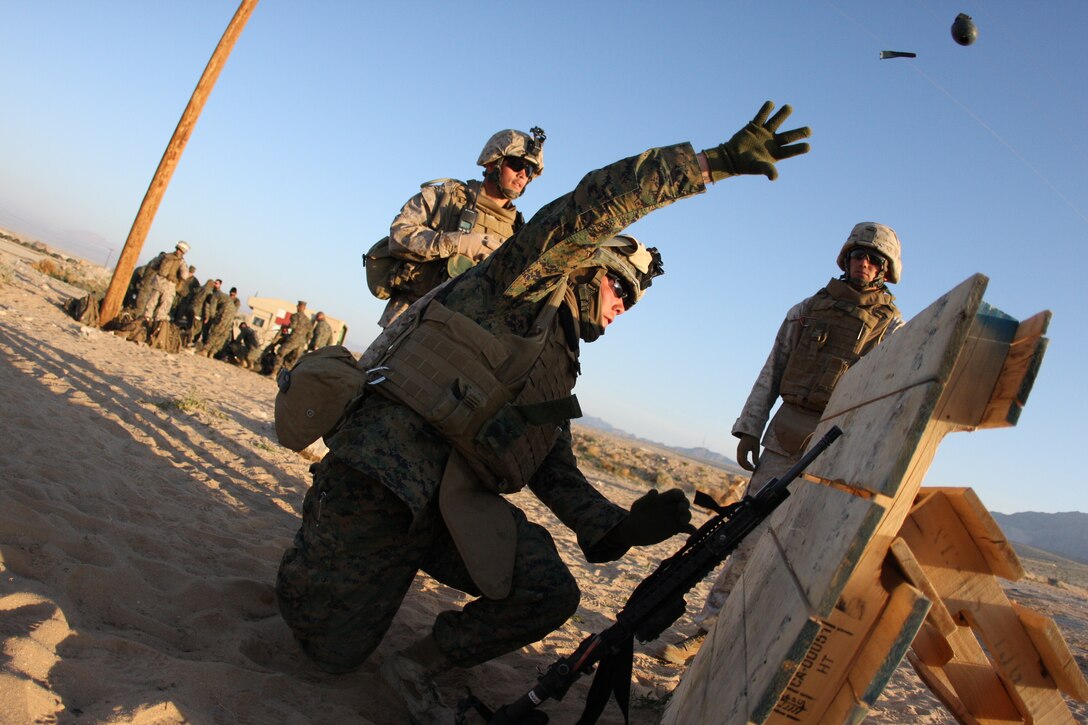 Lance Cpl. Kristofer Simmons, a fire team leader with Company F, 2nd Battalion, 7th Marine Regiment, throws a practice hand grenade into the kill zone of a simulated vehicle during a Tactical Small Unit Leaders Course on Range 105A aboard the Combat Center March 10 through March 19.  TSULC focuses on training team leaders with every weapon system they will use on patrols in a combat environment.