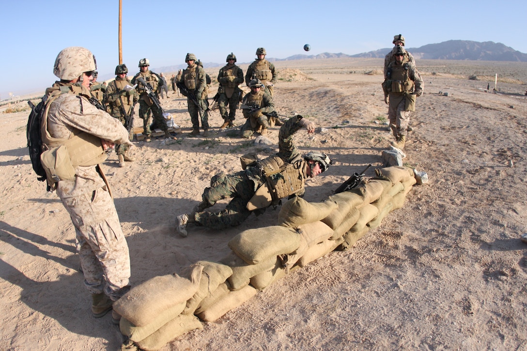 Lance Cpl. Kristofer Simmons, a fire team leader with Company F, 2nd Battalion, 7th Marine Regiment, throws a M69 practice hand grenade while in the prone position during a Tactical Small Unit Leaders Course on Range 105A aboard the Combat Center March 10 through March 19.  Students were taught how to throw a hand grenade in various positions and situations while taking cover.