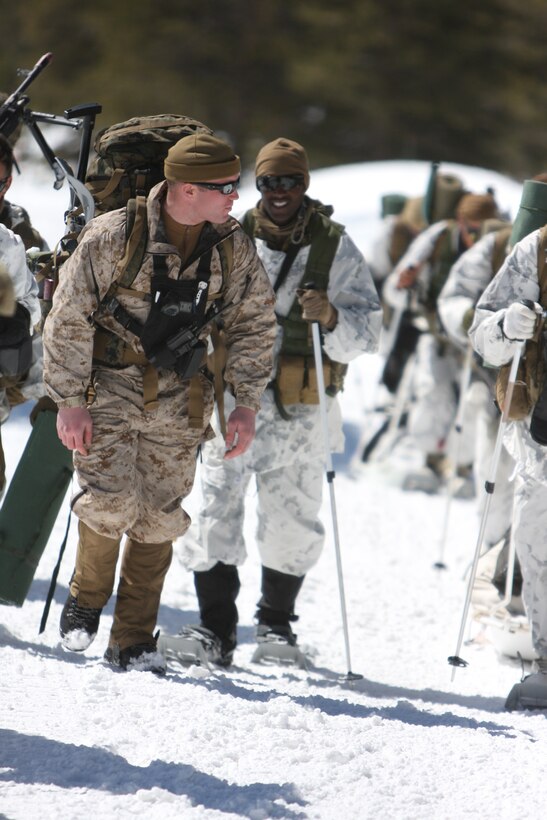 Sgt. Benjamin S. Mariano, an instructor with the Unit Training Group at the Marine Corps Mountain Warfare Training Center Bridgeport, Calif., finishes a hike to training area Woody while talking with one of the students from 3rd Battalion, 4th Marine Regiment, March 12.