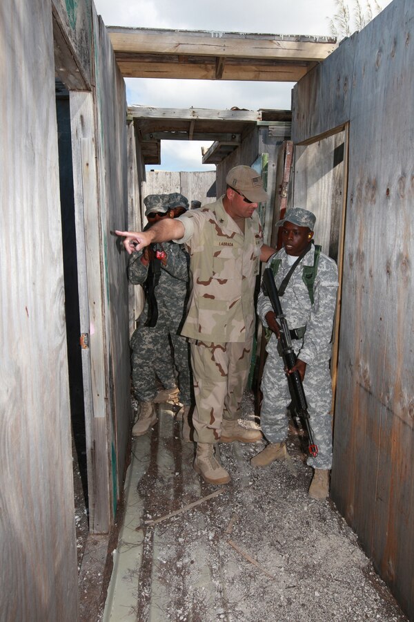 NASSAU, Bahamas (March 12, 2009) - Petty Officer 1st Class Fernando Labrada, from the Navy Maritime Civil Affairs Squadron 2, Detachment Bravo, instructs Dominican Republic Marines on how to clear a room of hostile personnel properly during close quarters battle training at the Royal Bahamas Defence Force Base in Coral Harbour.
