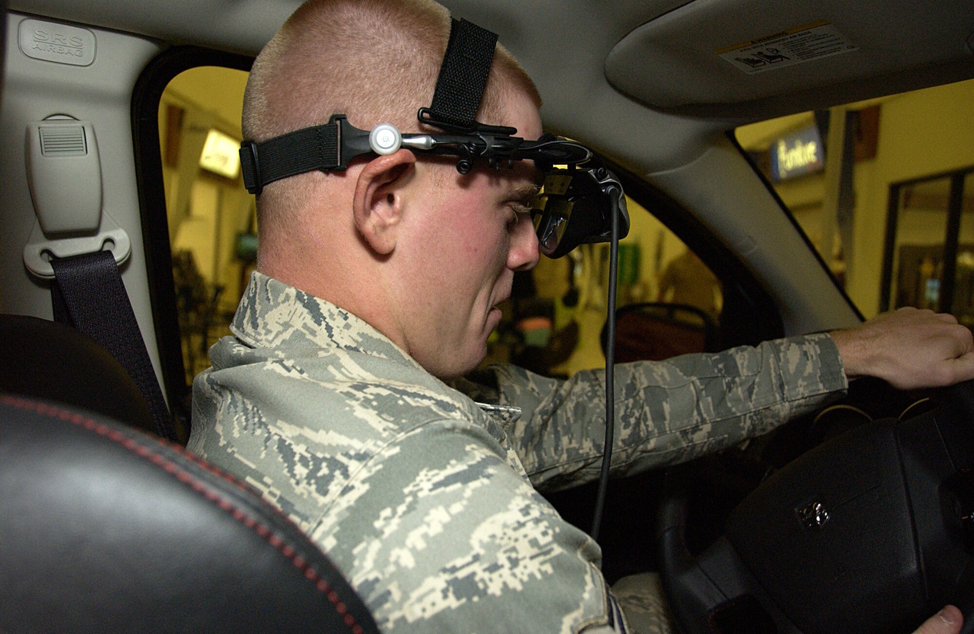 ANDERSEN AIR FORCE BASE, Guam -- Airman 1st Class Michael Bullard, 554th RED
HORSE Squadron operations manager, takes the Drive Smart program for a spin
at the base exchange March 10. Through panoramic virtual reality goggles,
the Drive Smart DUI simulator generates imagery by taking cues from the
driver's reactions while seated in the driver's seat of an actual vehicle.
(U.S. Air Force photo by Airman Carissa Wolff)
