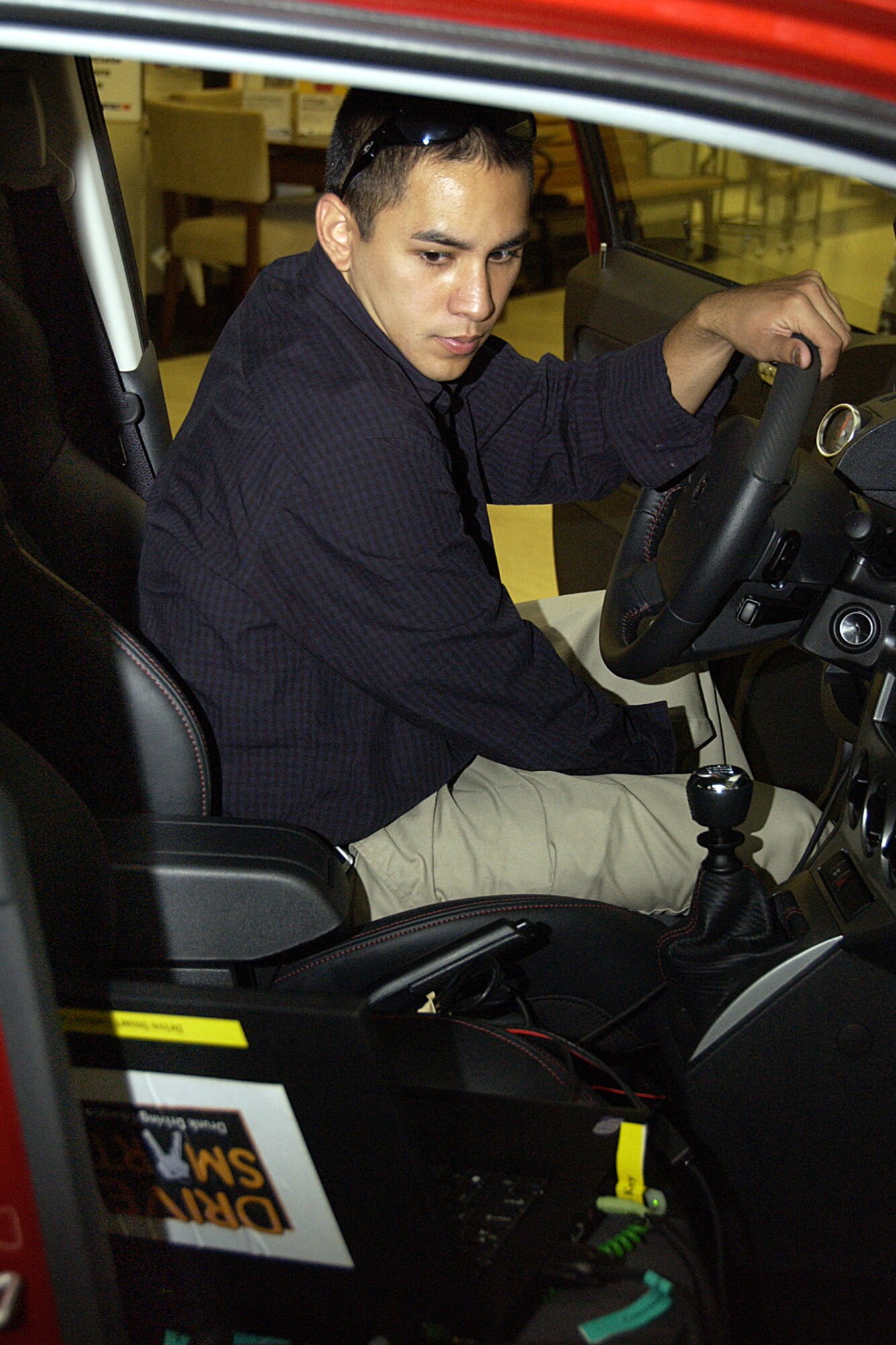 ANDERSEN AIR FORCE BASE, Guam -- Garret Lord, New Exchange Car Sales
Chrysler sales agent, calibrates the Drive Smart DUI simulator at the base
exchange March 10. The $40,000 simulator is a virtual interactive experience
that mimics the dangers of driving under the influence of alcohol. (U.S. Air
Force photo by Airman Carissa Wolff)
